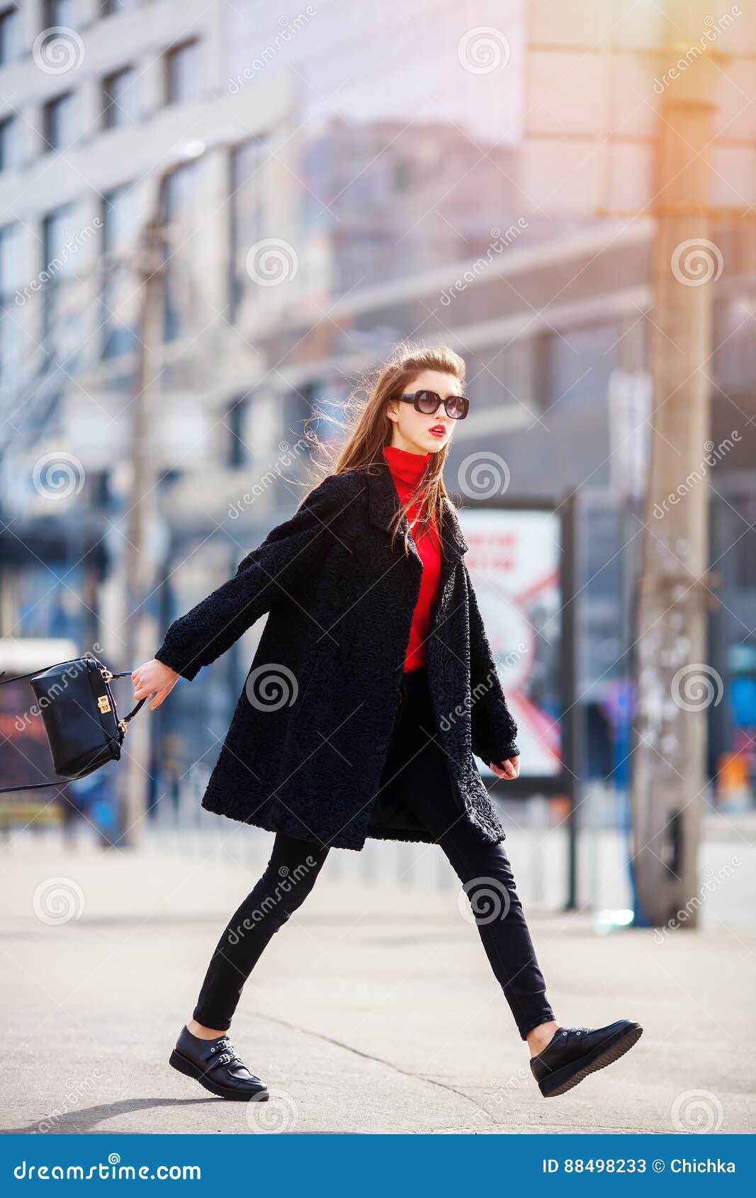 attractive woman in autumn style trendy outfit walking in street