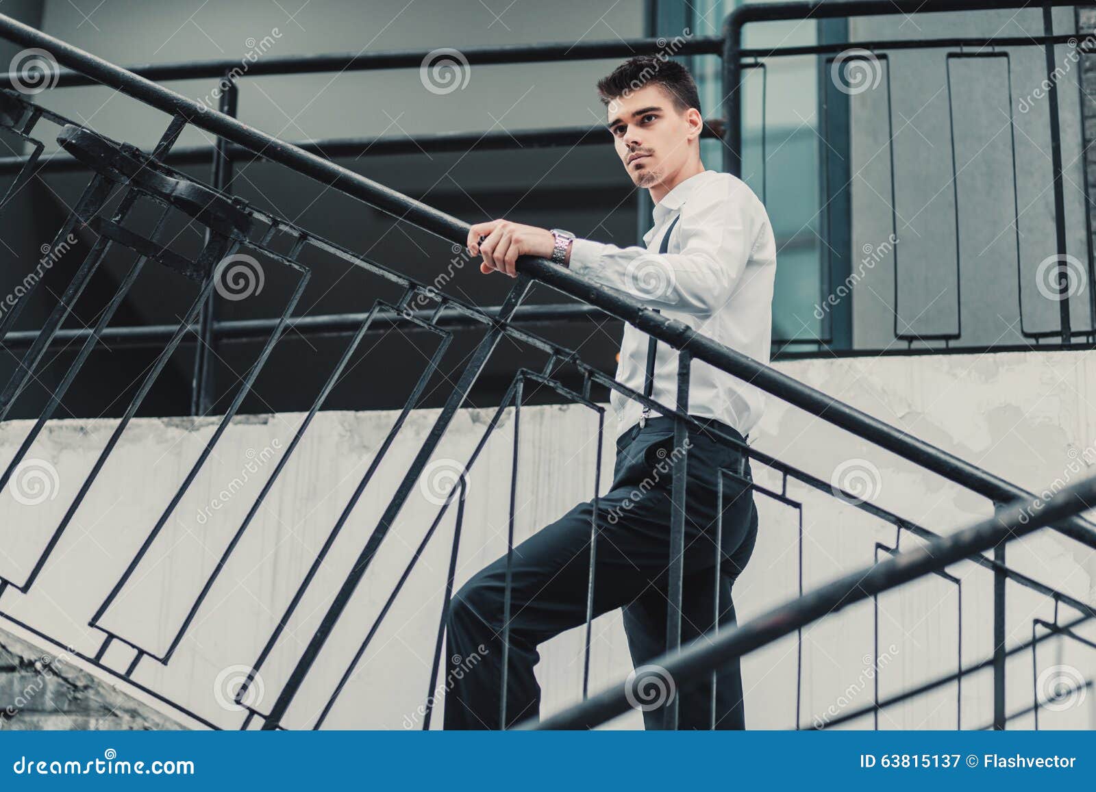 Young Stylish Man Model in Classic Clothes Posing Near Stairs. Fashion ...