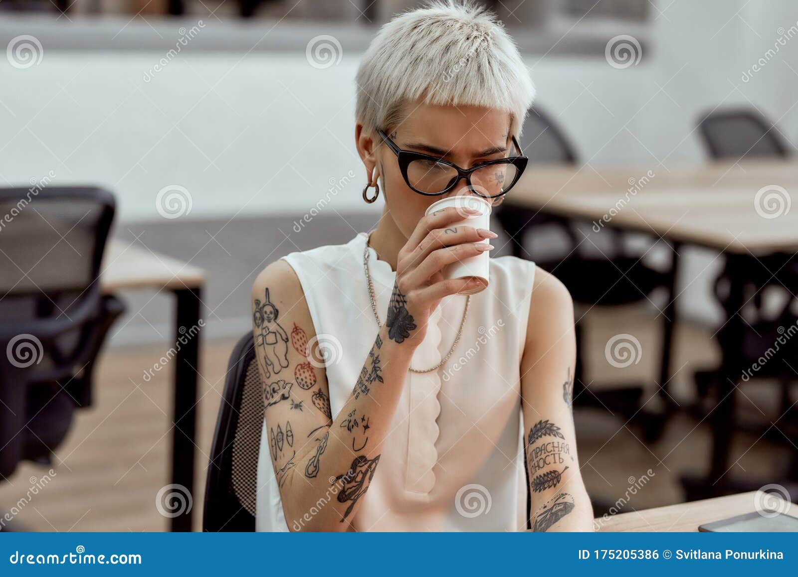 Job is My Life. Young Tattooed Blonde Business Woman in Eyewear Drinking  Coffee while Working in the Modern Office Stock Photo - Image of blonde,  female: 175205386