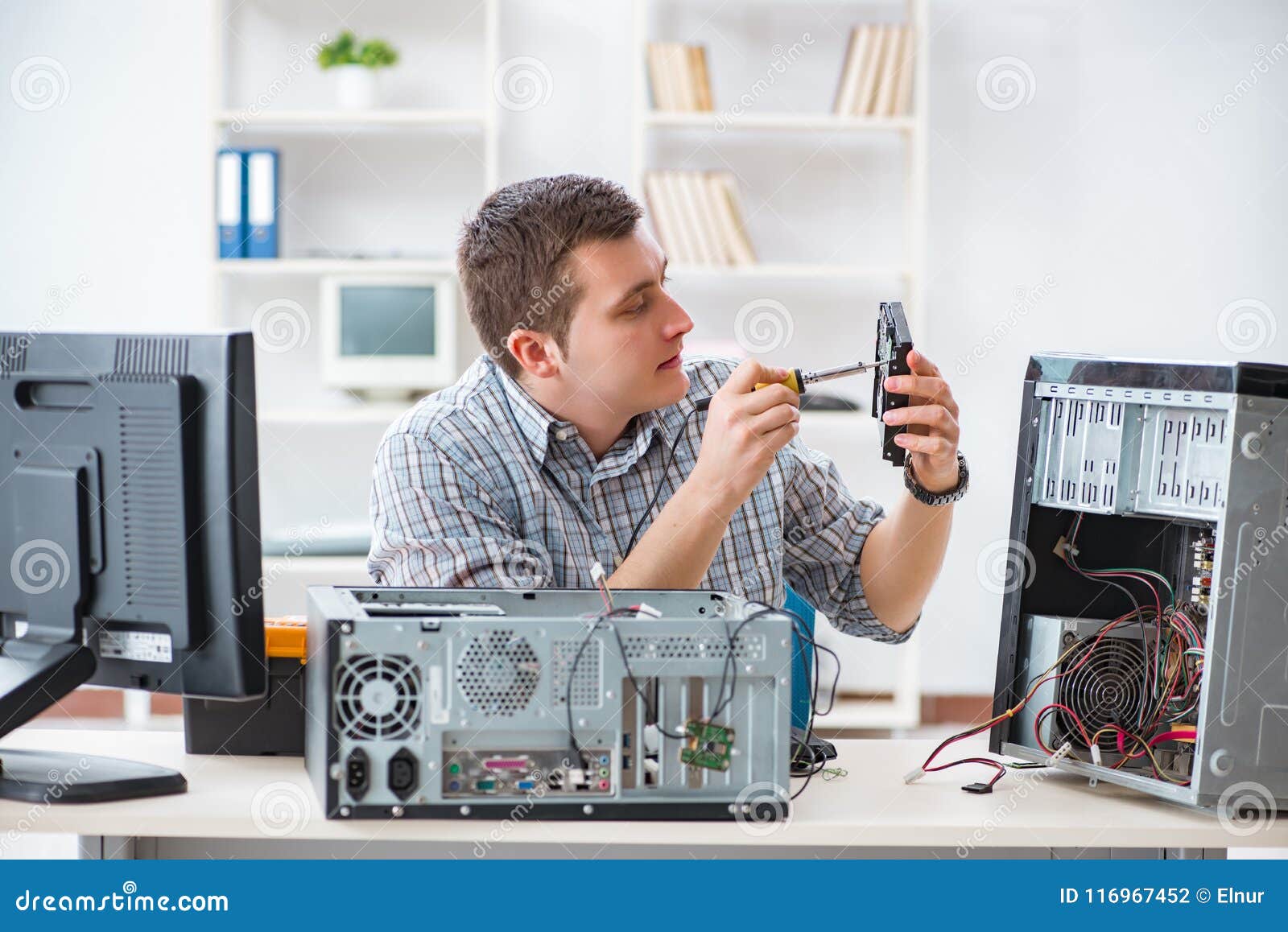 The Young Technician Repairing Computer in Stock Photo Image