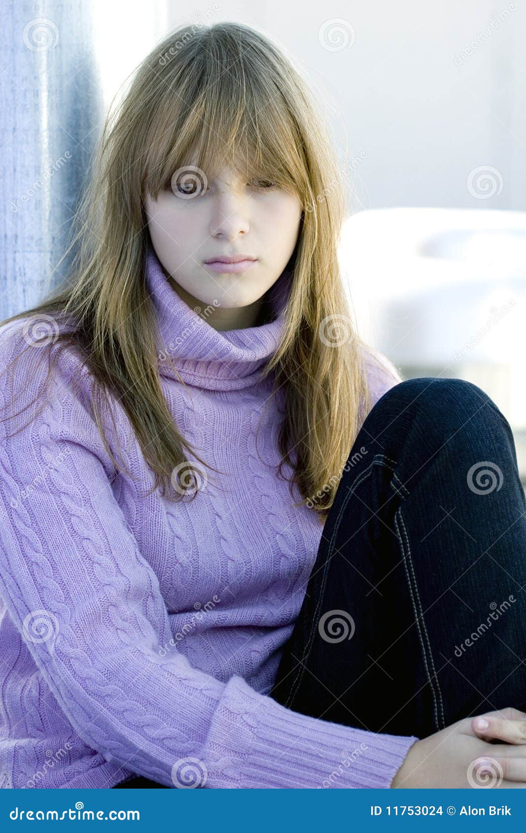 Young Teenager Girl Sitting With Depressed Face Stock Photo