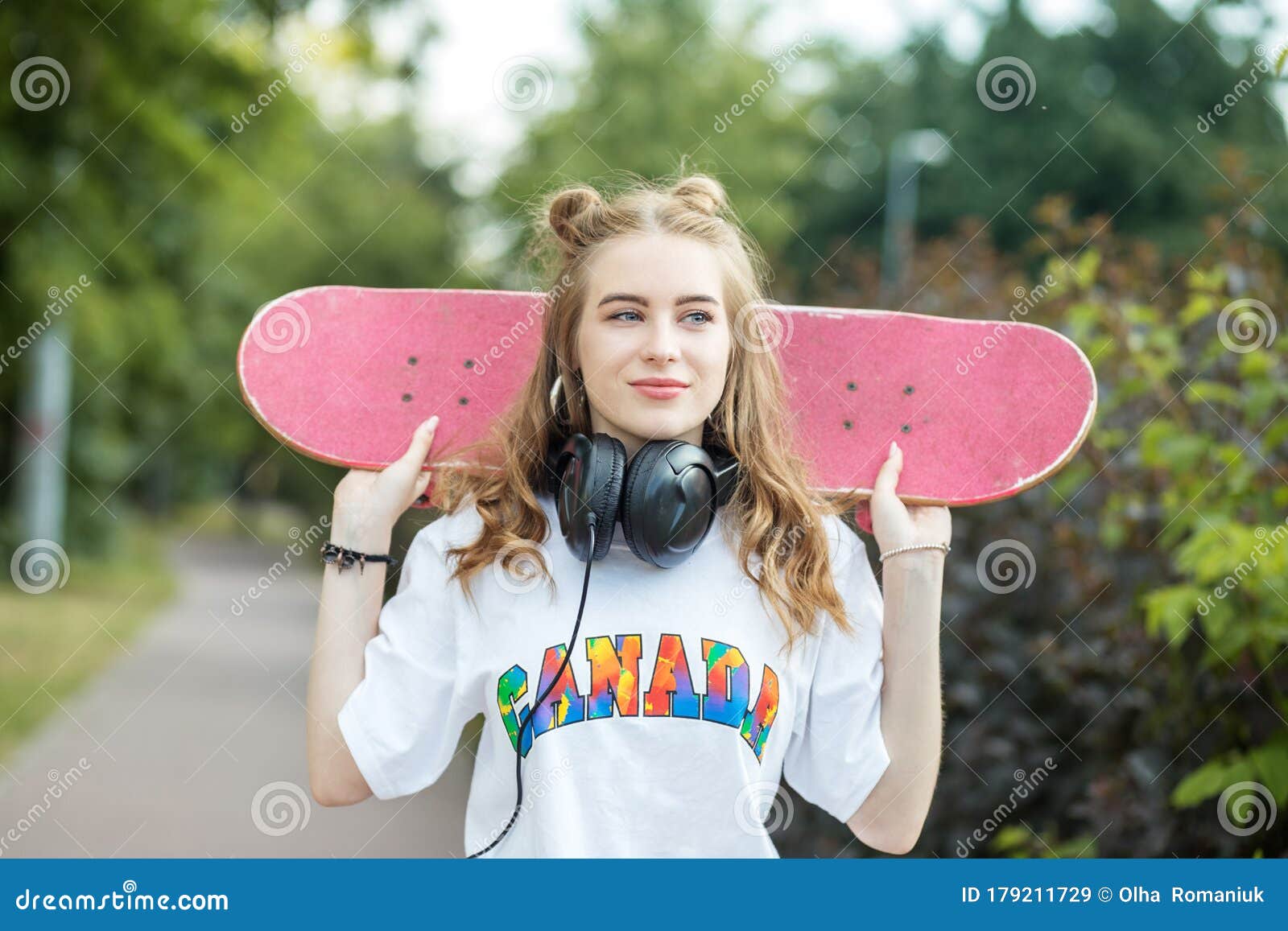 Young Teenager Girl with a Skateboard. Headphones. the Concept of an ...
