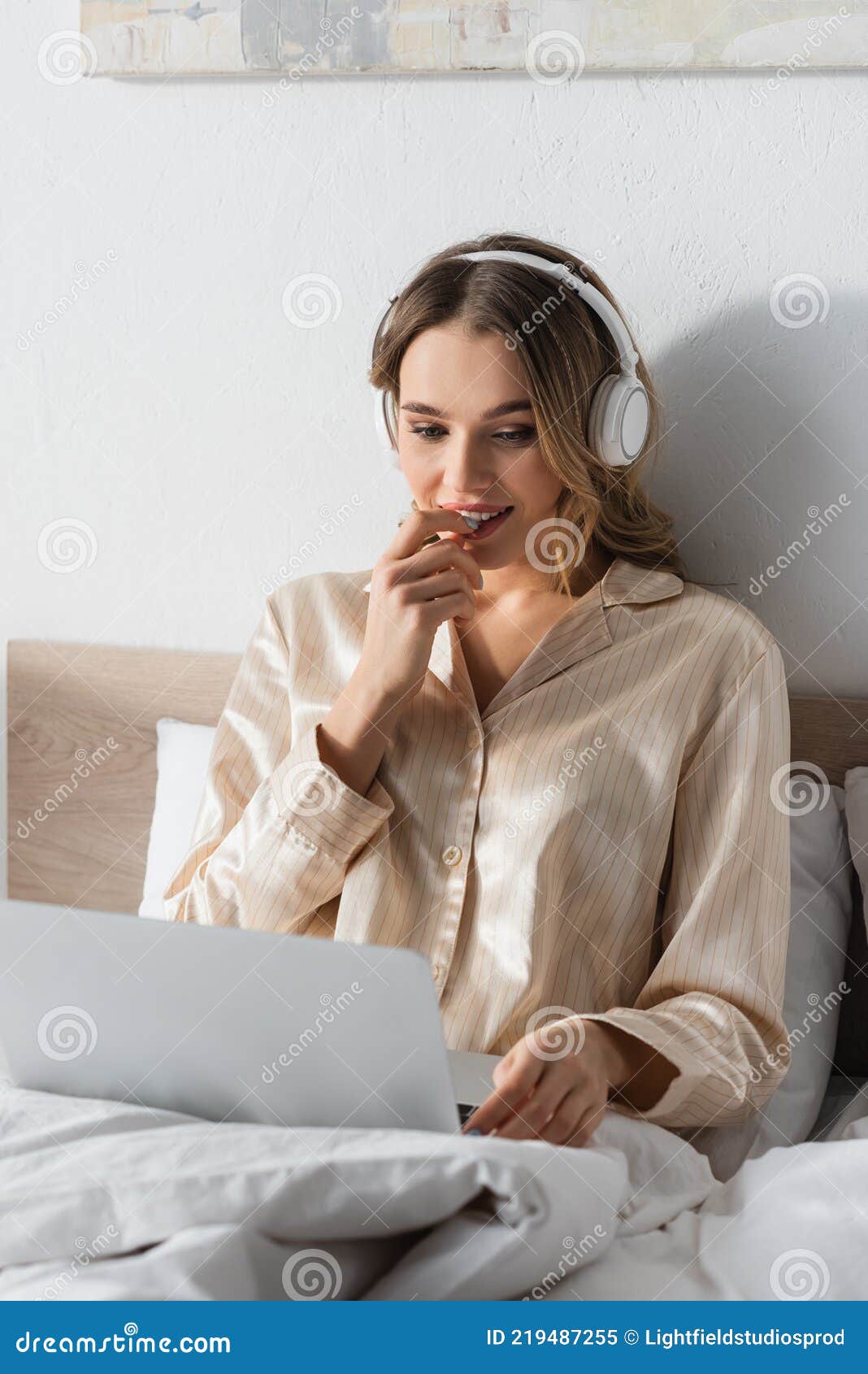 young teleworker in headphones using blurred
