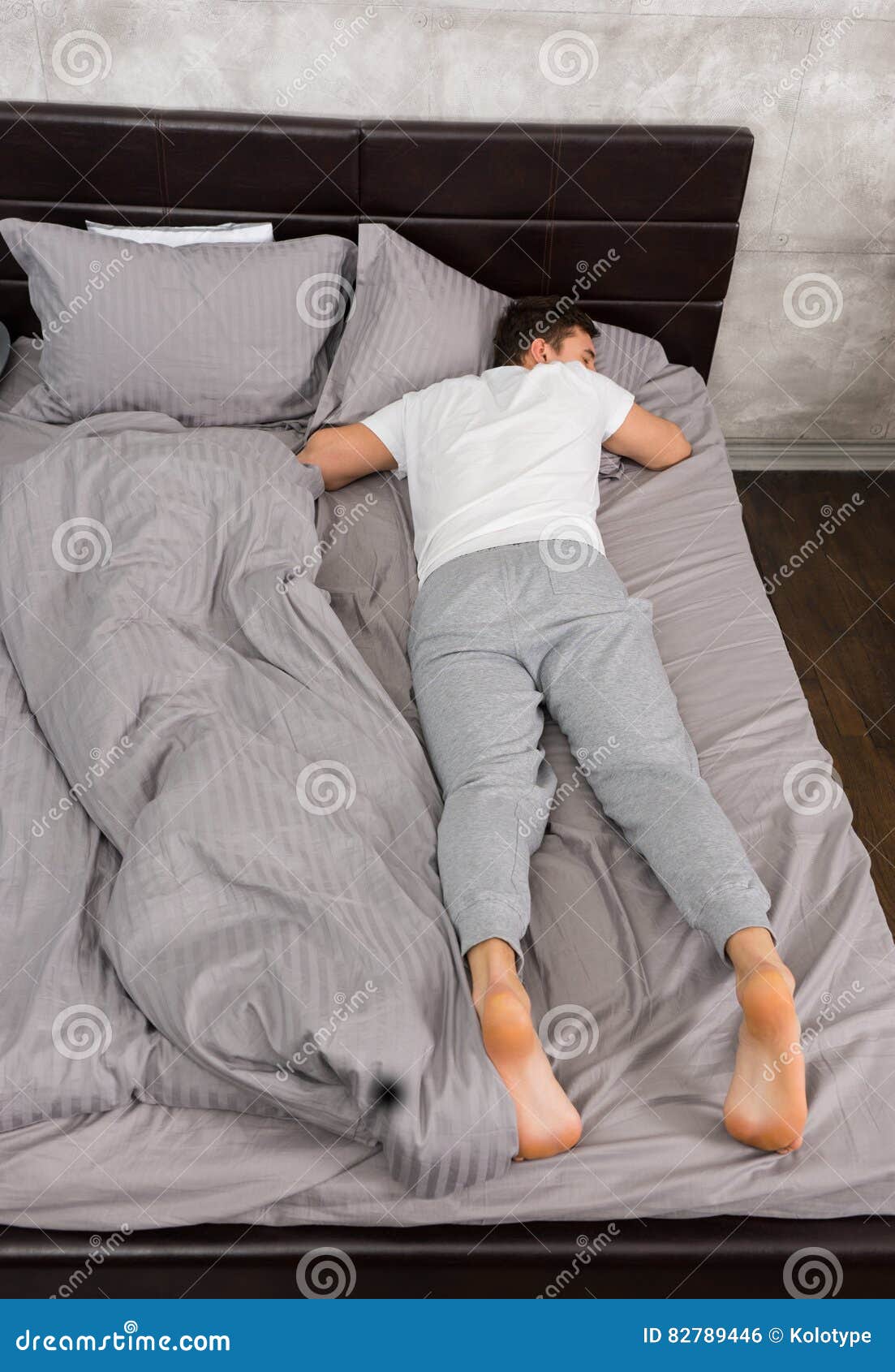Young Tired Male in Pajama Sleeping without Blanket in Stylish B Stock ...