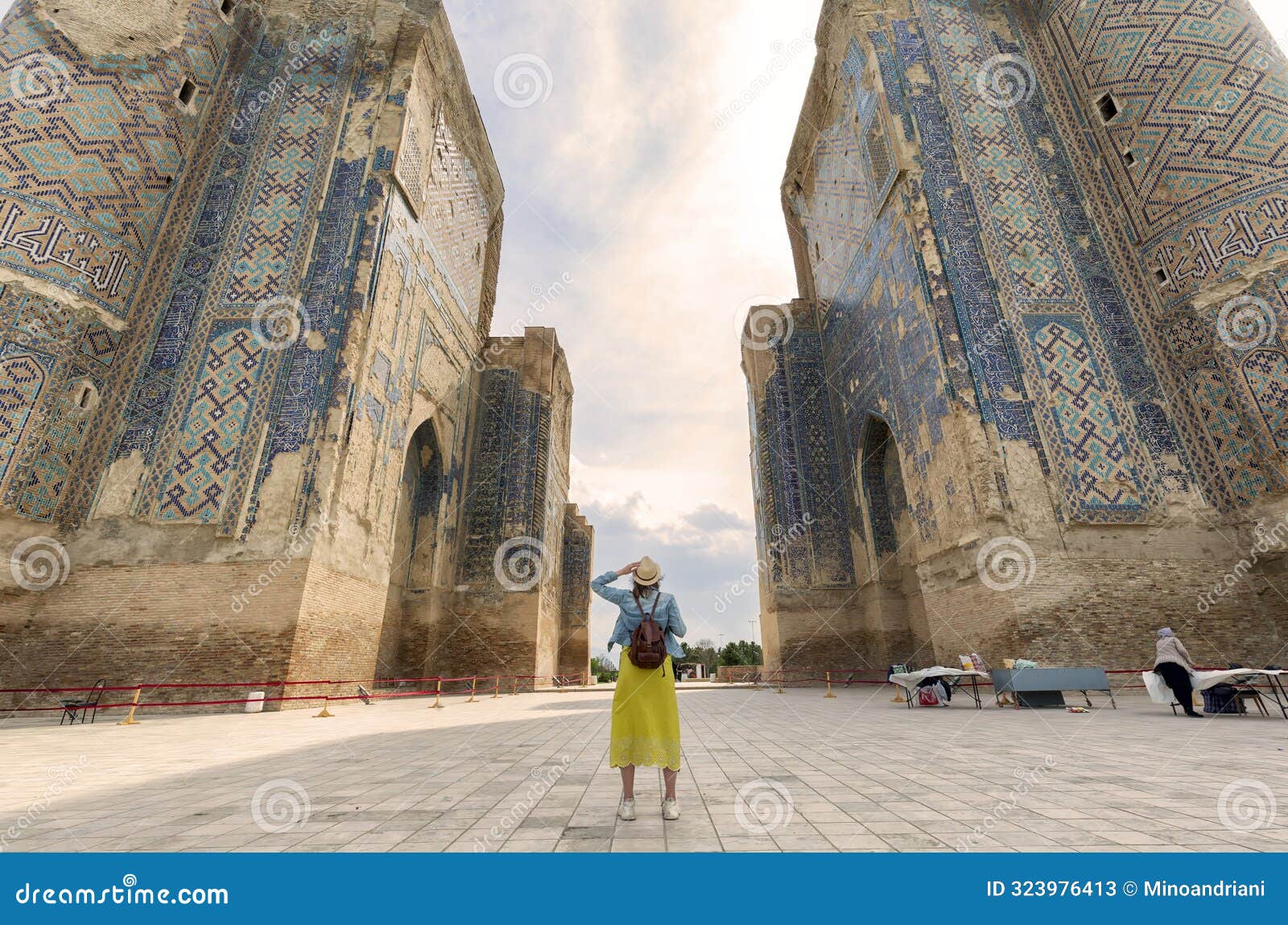 young tourist looking the gate of ak saray palace, built during time of timur, shakhrisabz, uzbekistan.