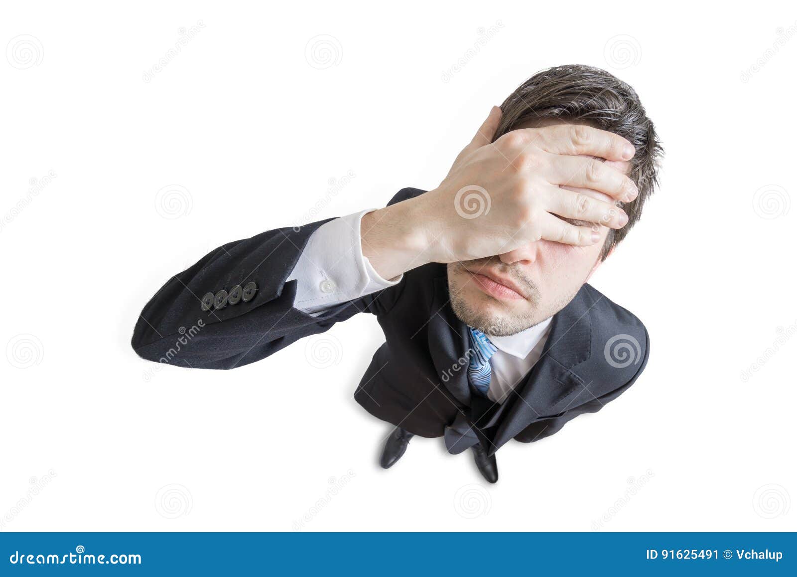 young unhappy and stressed man made mistake and is covering his face with hand.  on white background. view from top