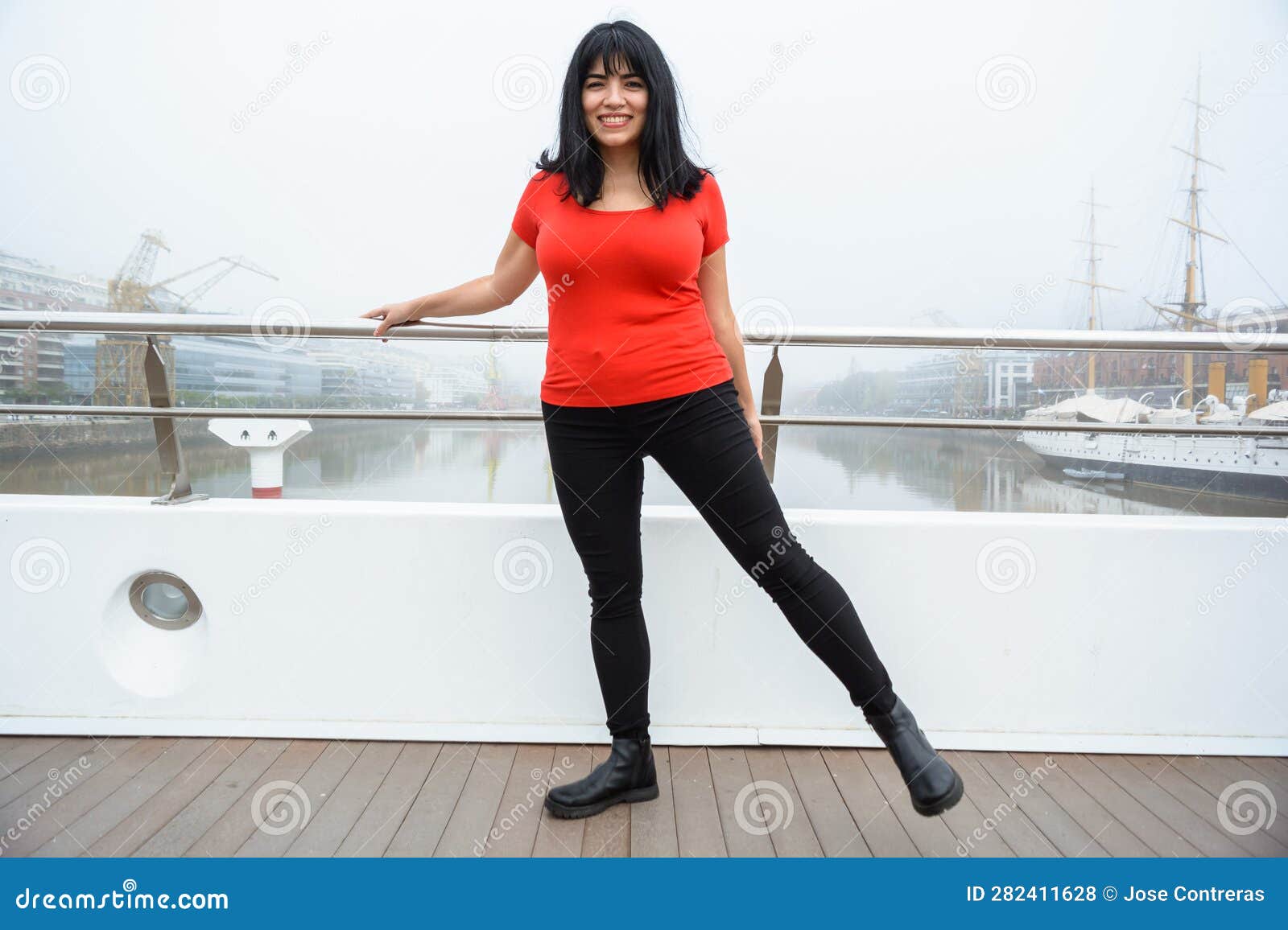 young venezuelan latina tourist enjoying the day standing on the puente de la mujer in buenos aires