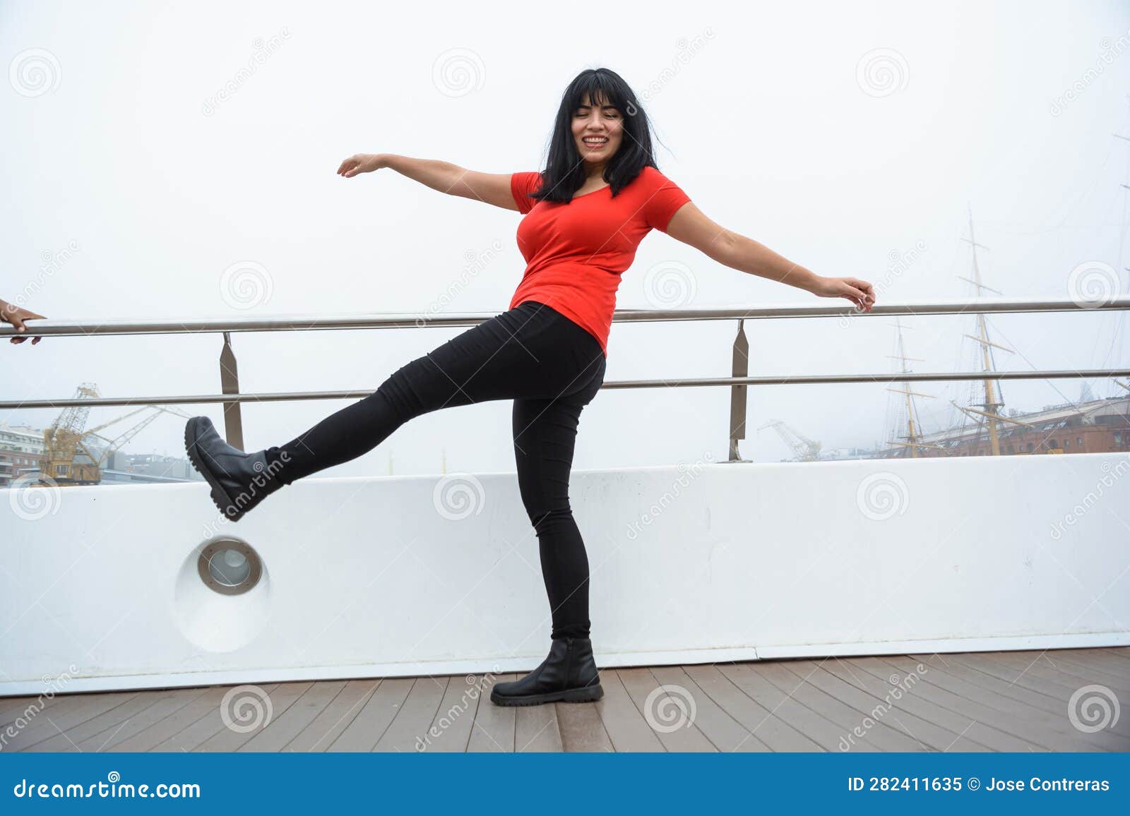 young venezuelan latina tourist enjoying the day standing on the puente de la mujer in buenos aires
