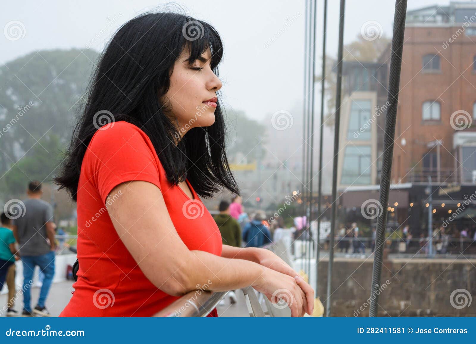 young latin woman leaning on the puente de la mujer in buenos aires calm with her eyes closed
