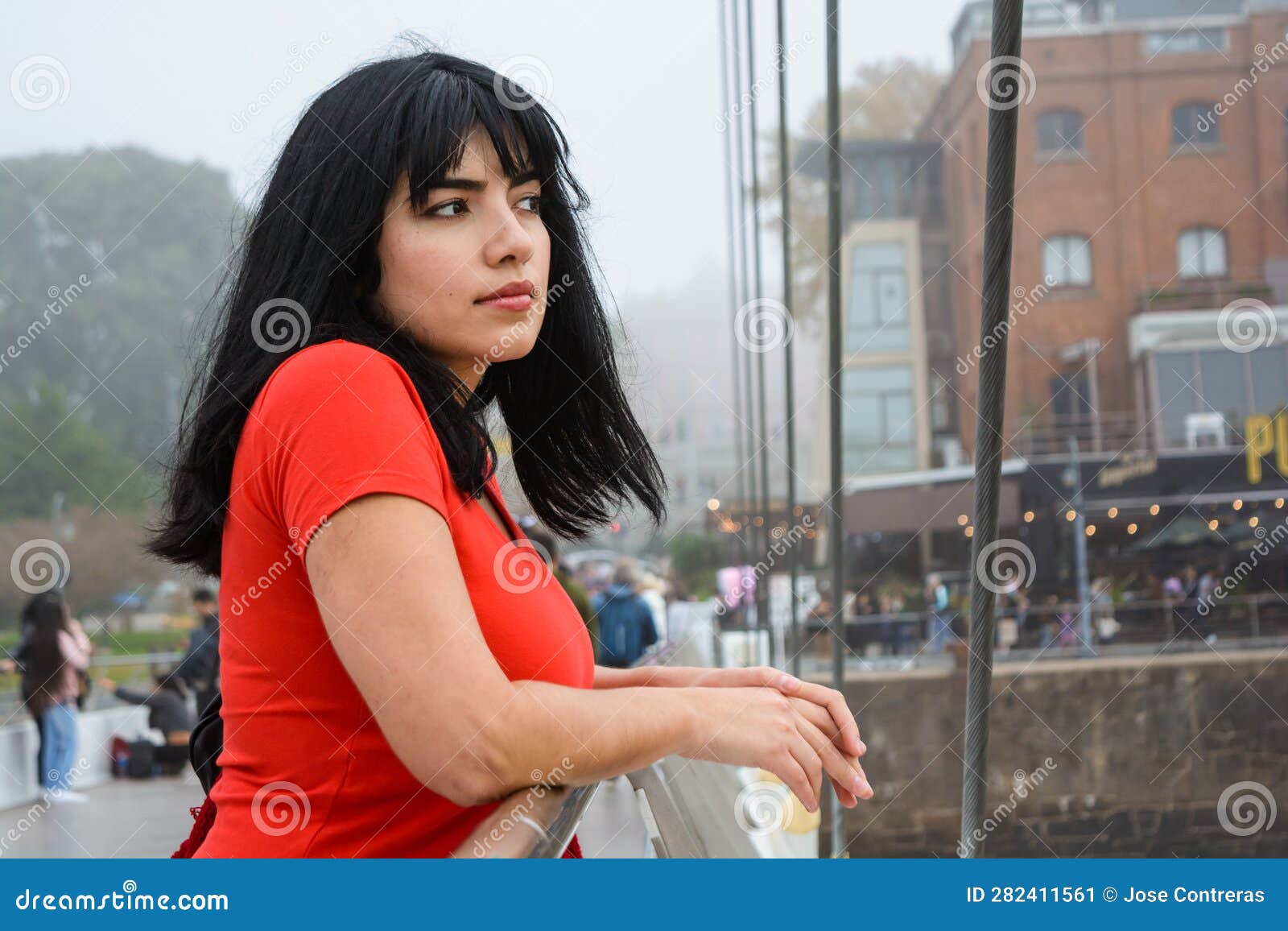 young venezuelan tourist in puerto madero stop at el puente de la mujer watching and thinking