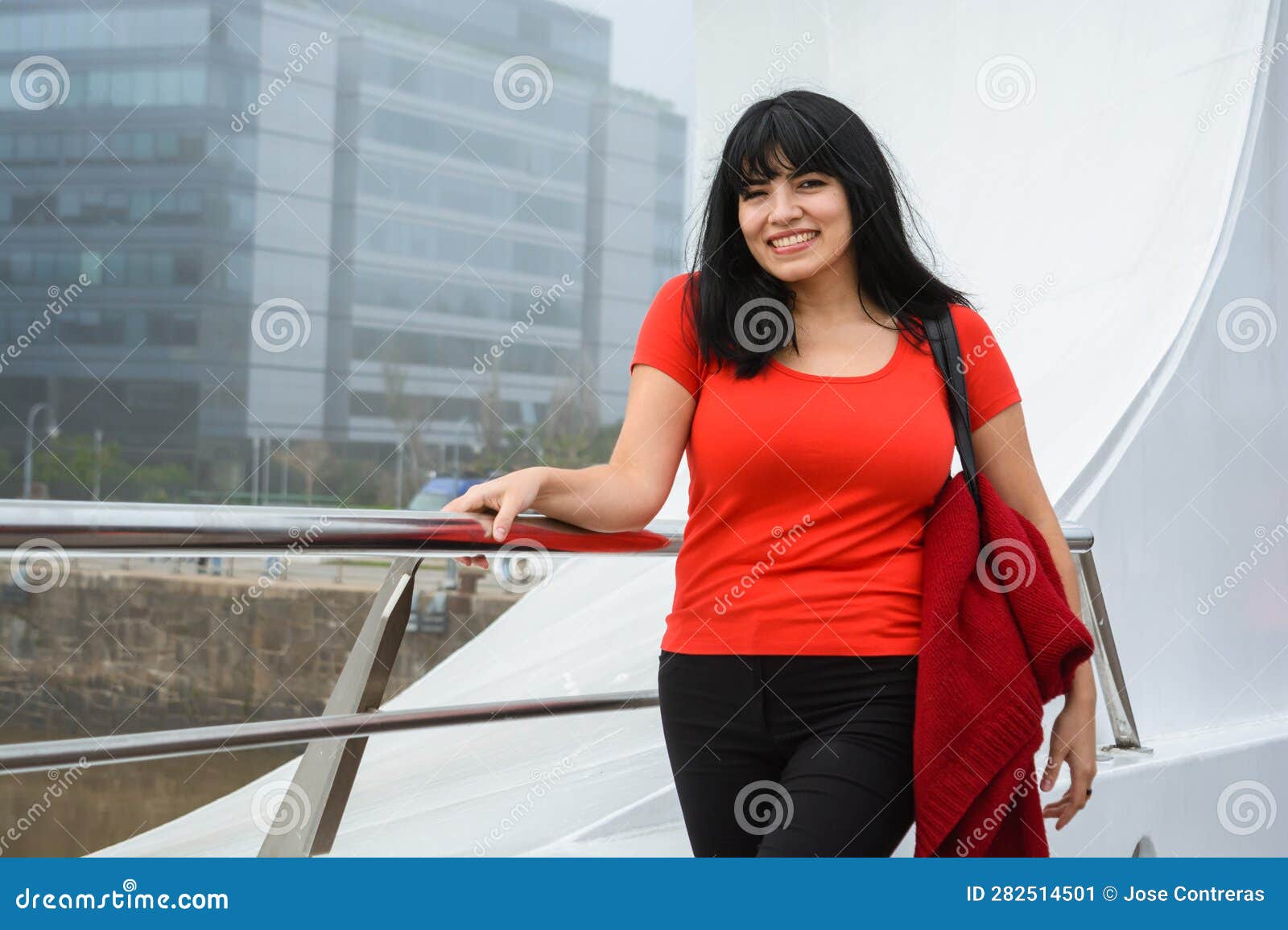 young venezuelan woman smiling looking at the camera standing on the puente de la mujer in buenos aires