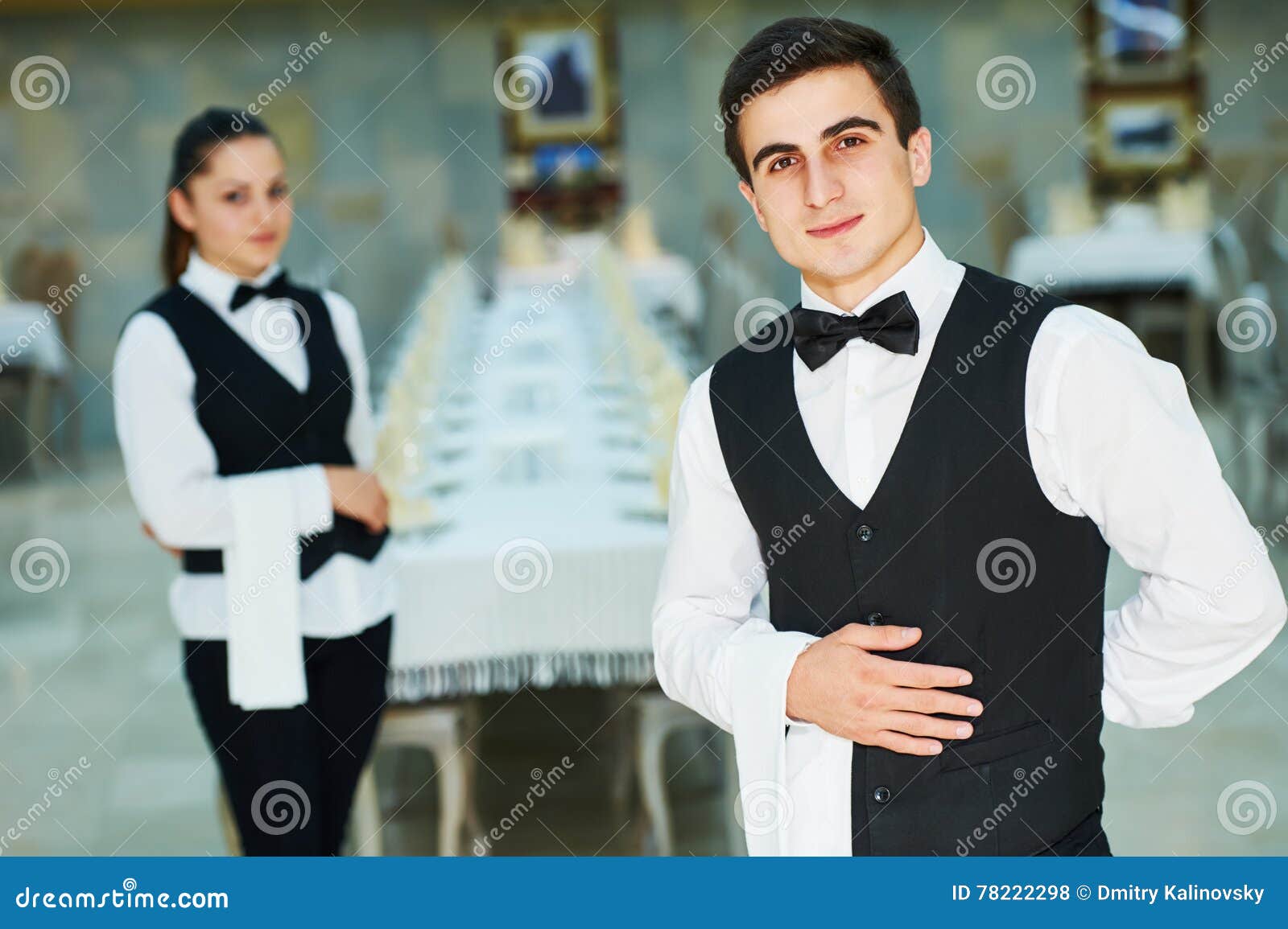young waiter and waitress at service in restaurant