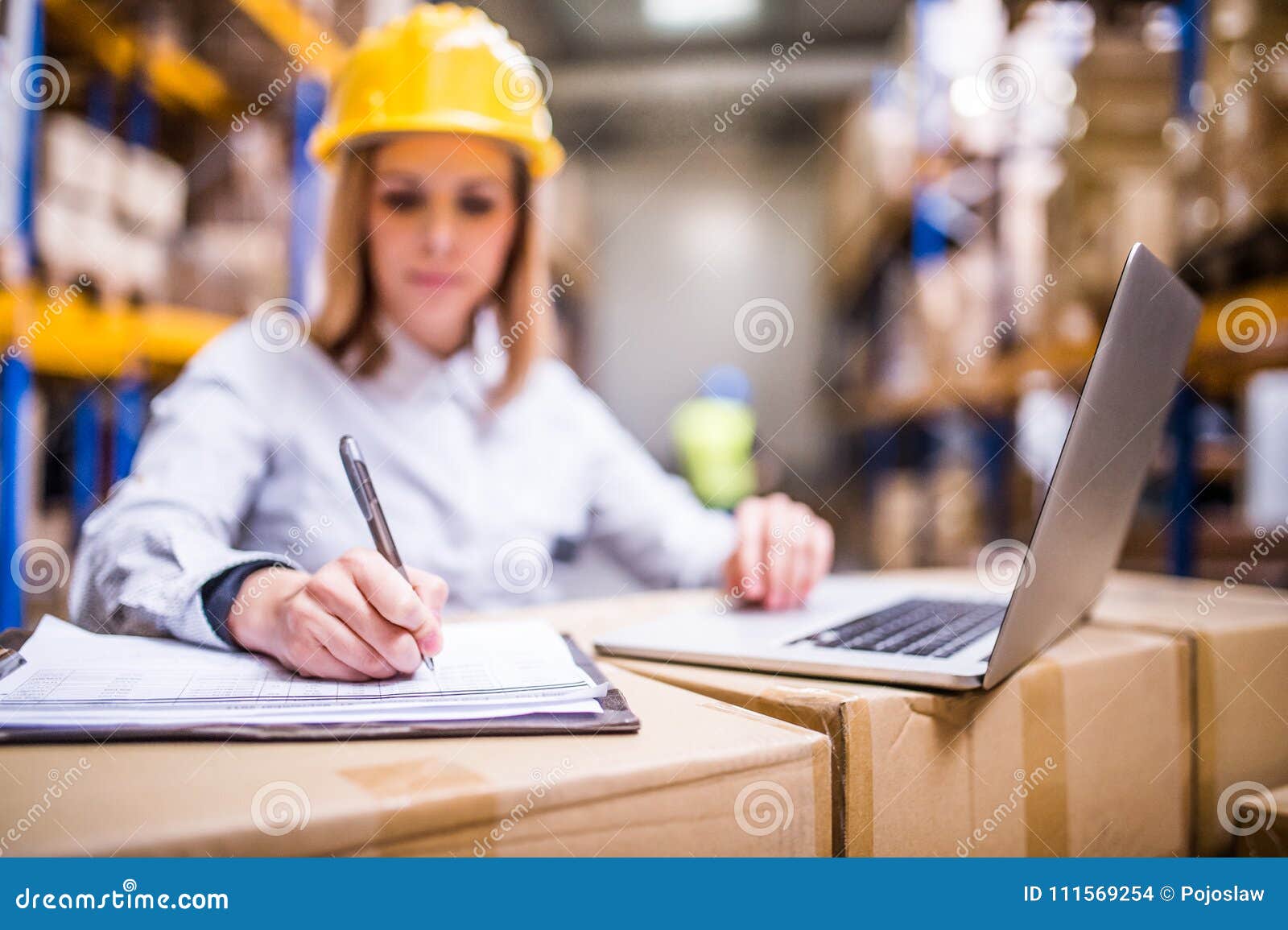 Young Warehouse Worker with Laptop Working. Stock Photo Image of