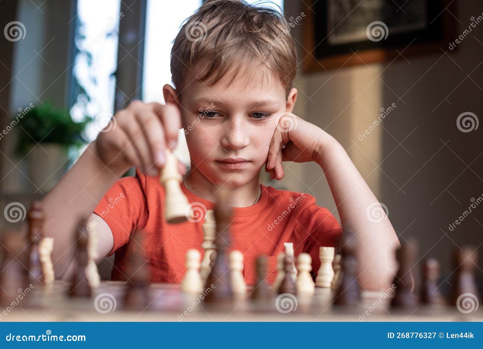 Young white child playing a game of chess on large chess board. Chess board  on table in front of school boy thinking of next move by Len44ik Vectors &  Illustrations with Unlimited