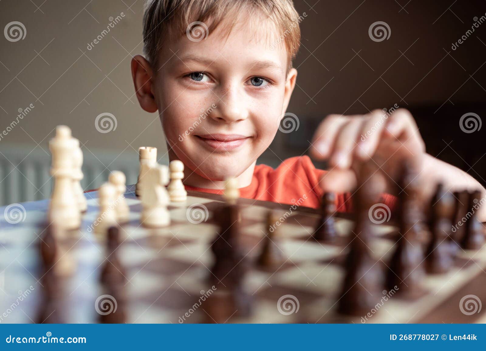 Premium Photo  Young white child playing a game of chess on large chess  board chess board on table in front of school boy thinking of next move