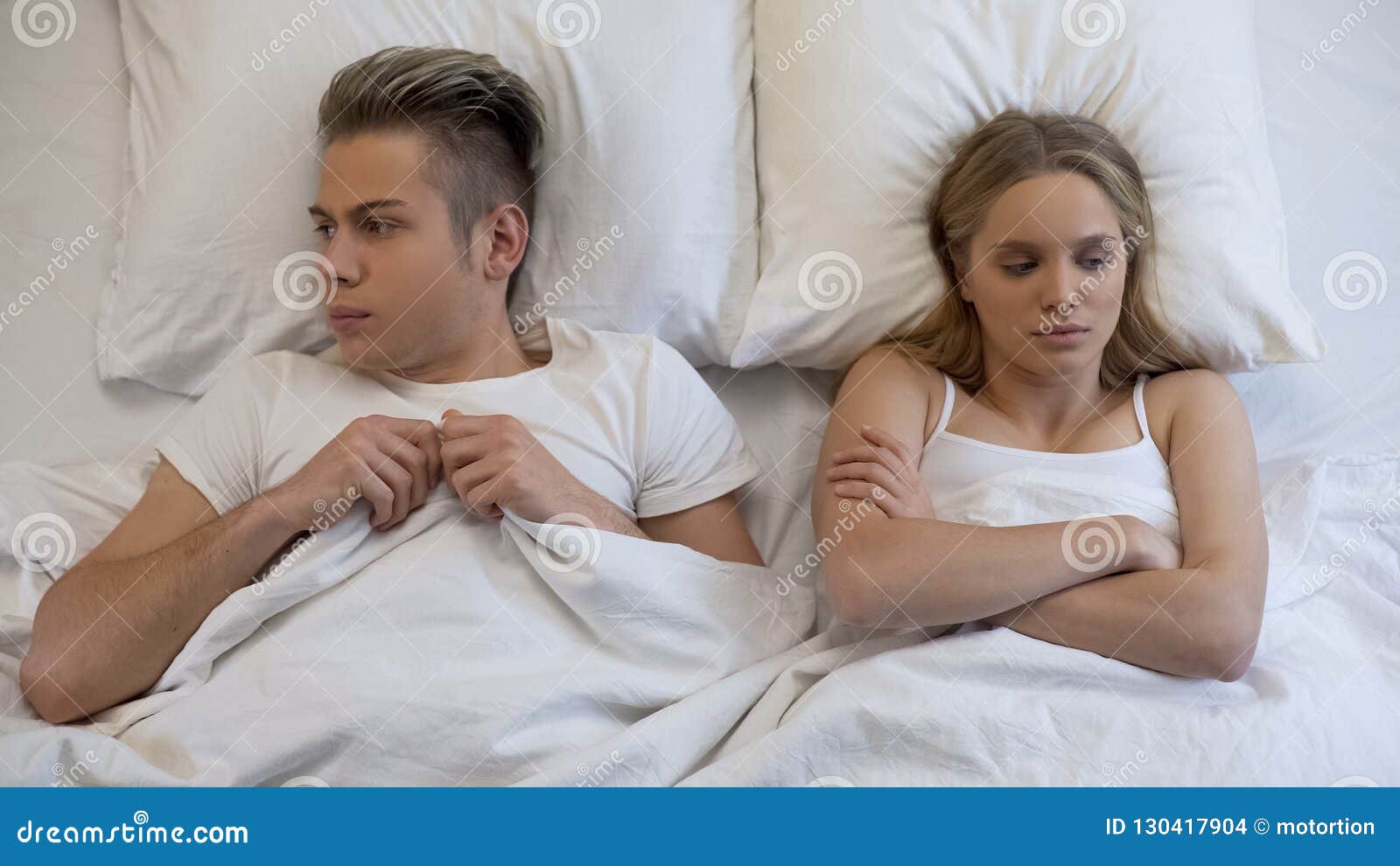 Young Wife Looking Dissatisfied with First Sex Experience, Embarrassed Boyfriend Stock Photo picture