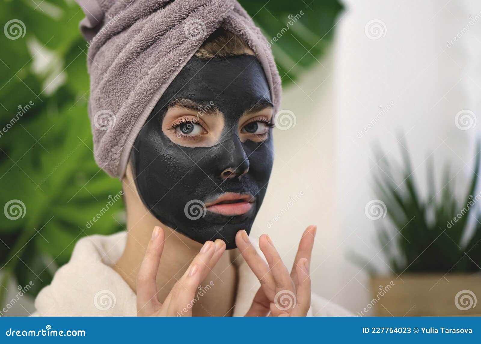 Young Woman Applying Black Face Mask on Her Face Stock Image - Image of ...