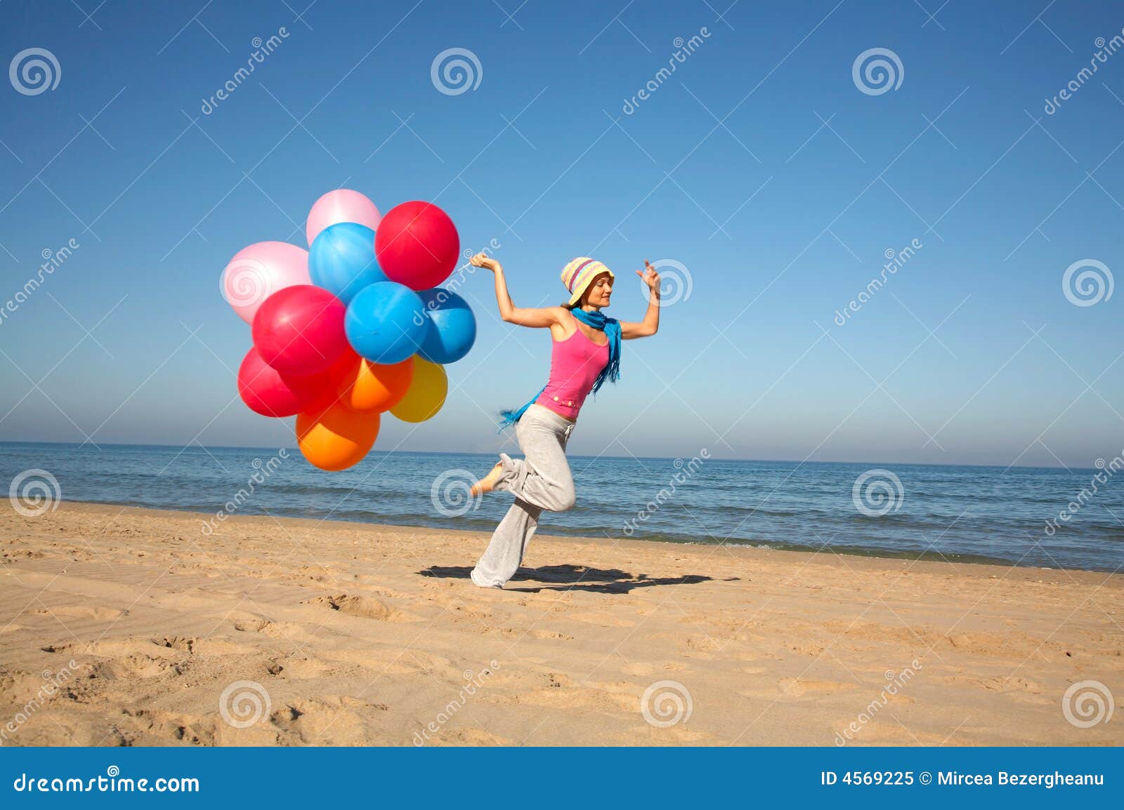 Young Woman With Balloons Running On The Beach Royalty Free Stock Photo