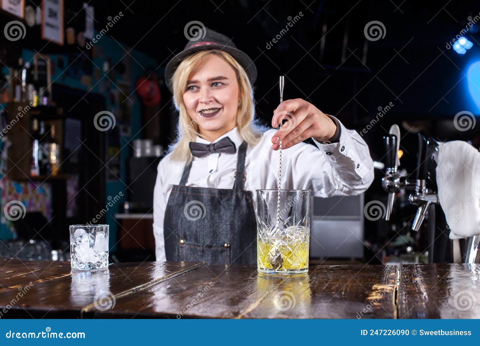 Confident Woman Bartending Formulates a Cocktail Behind the Bar Stock ...