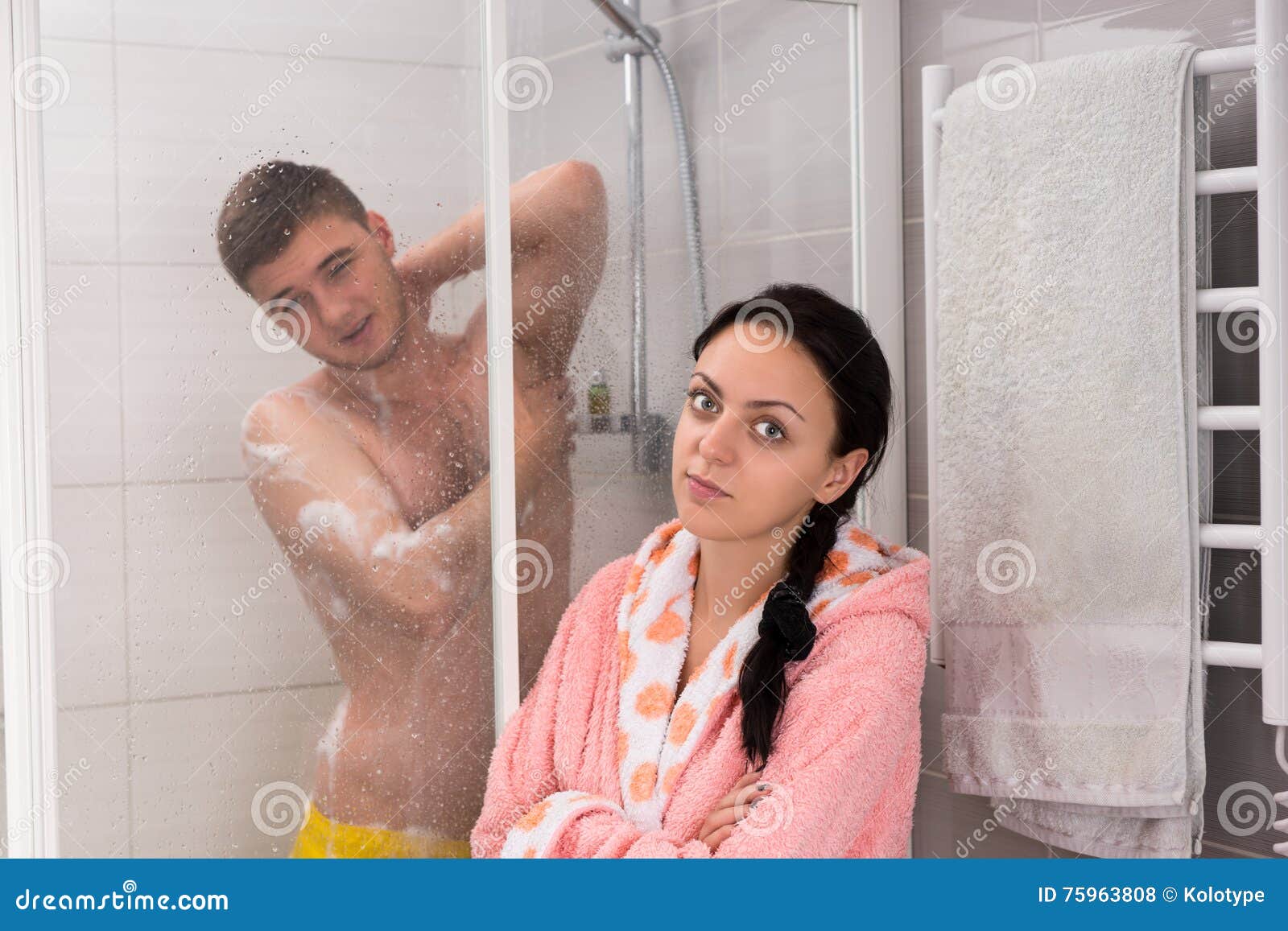 rubbing herself with a washing cloth in the shower and lot of foam