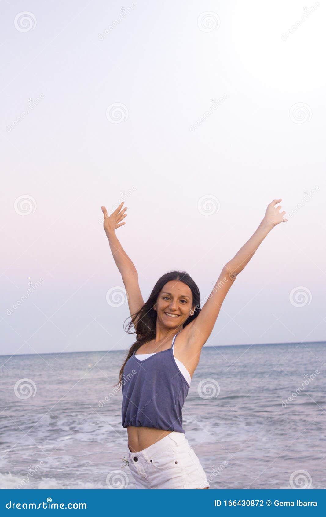 young woman on the beach in very positive and happy attitude