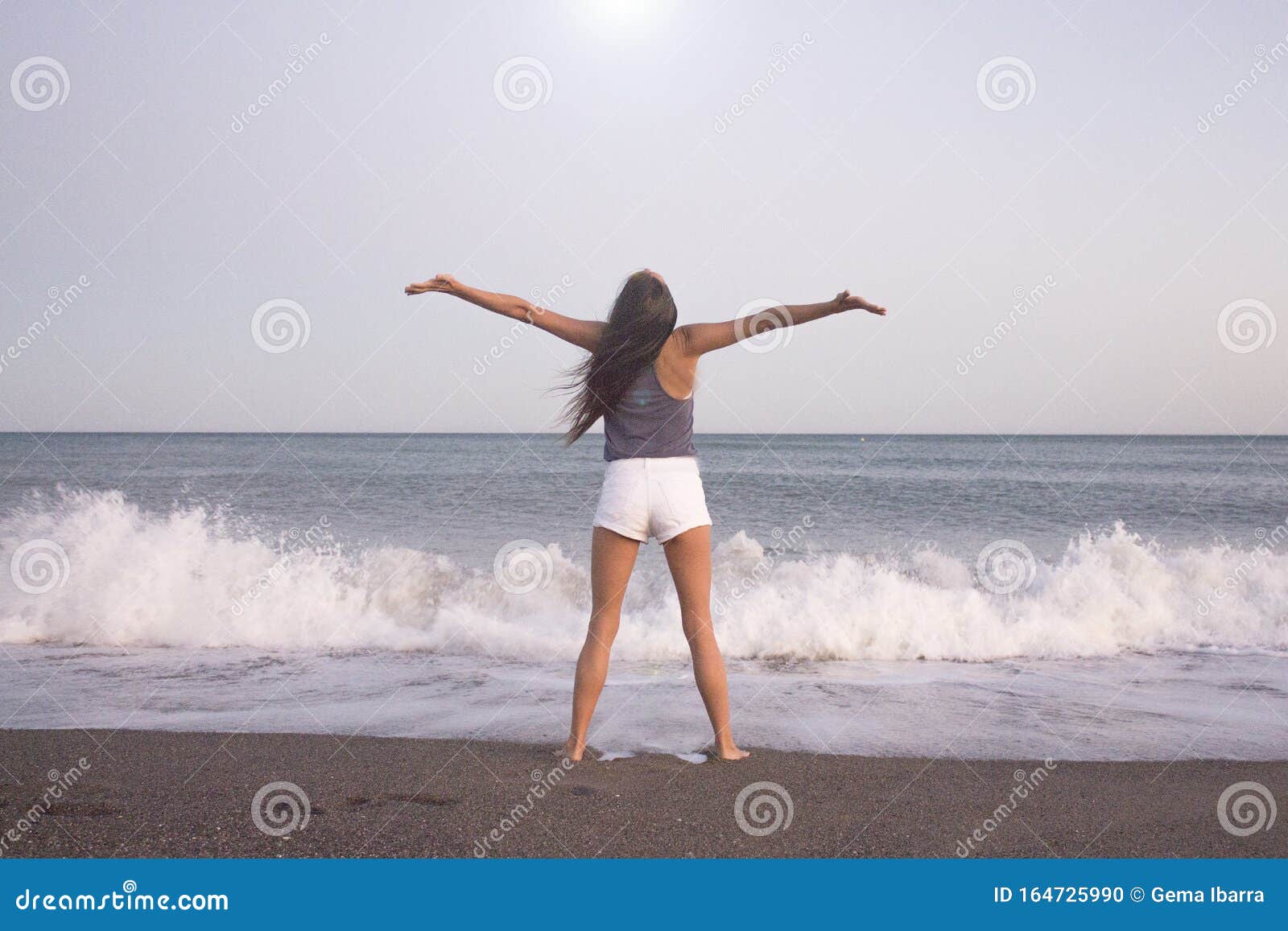 young woman on the beach in very positive and happy attitude