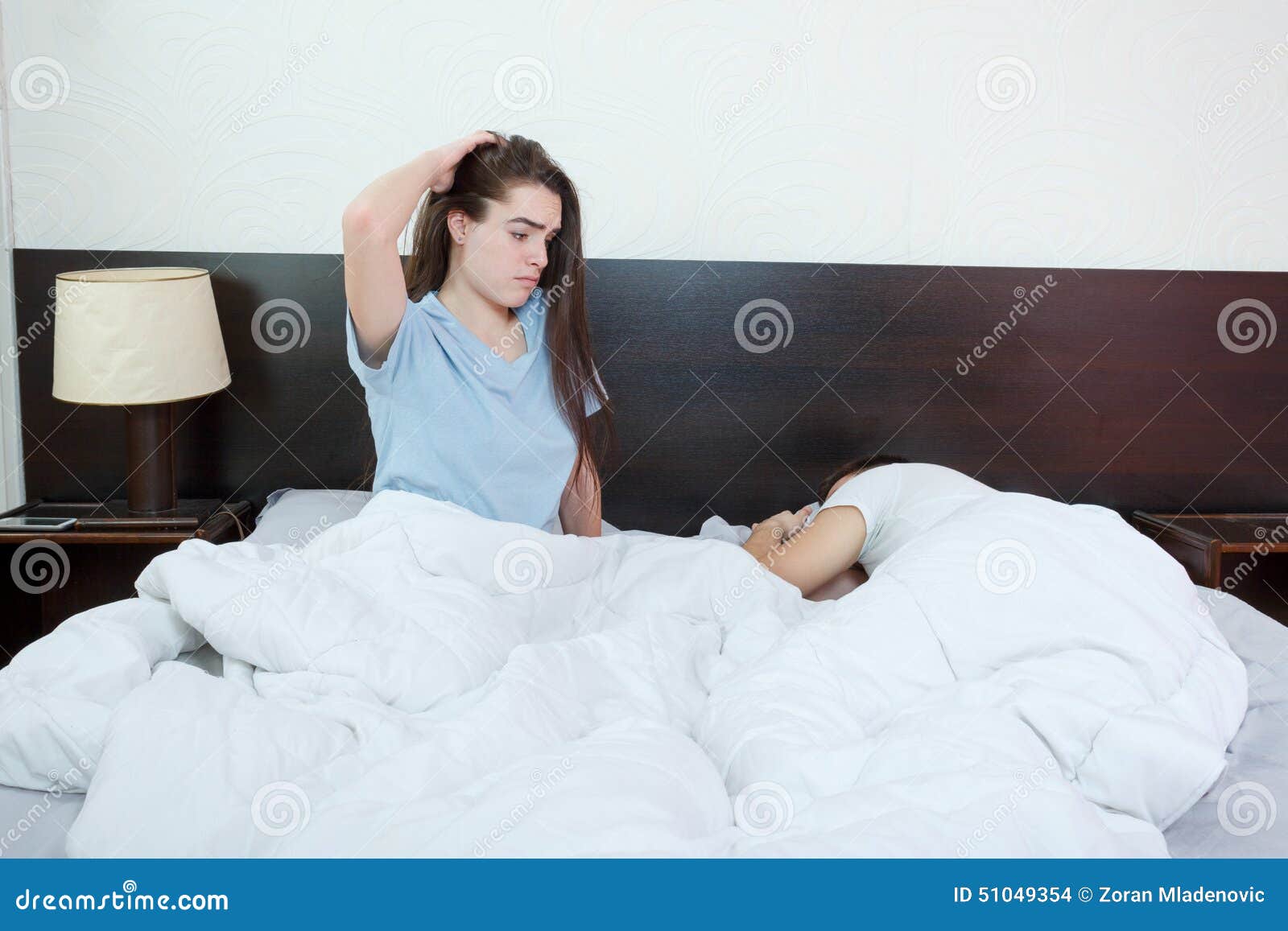 Young Woman in Bed with Sad Expression on Her Face, Sex Problems Stock Photo