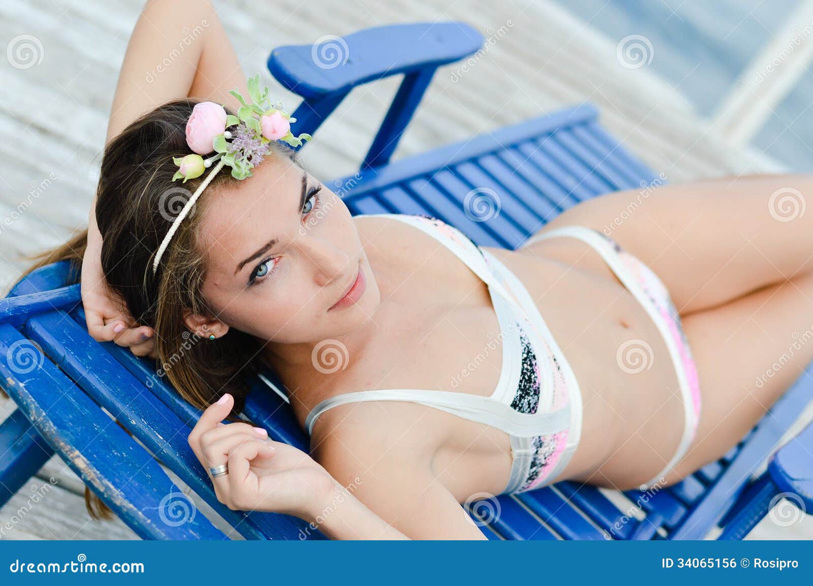 Young Woman in Bikini Enjoying Sunny Day on Sun Lounge Stock Photo