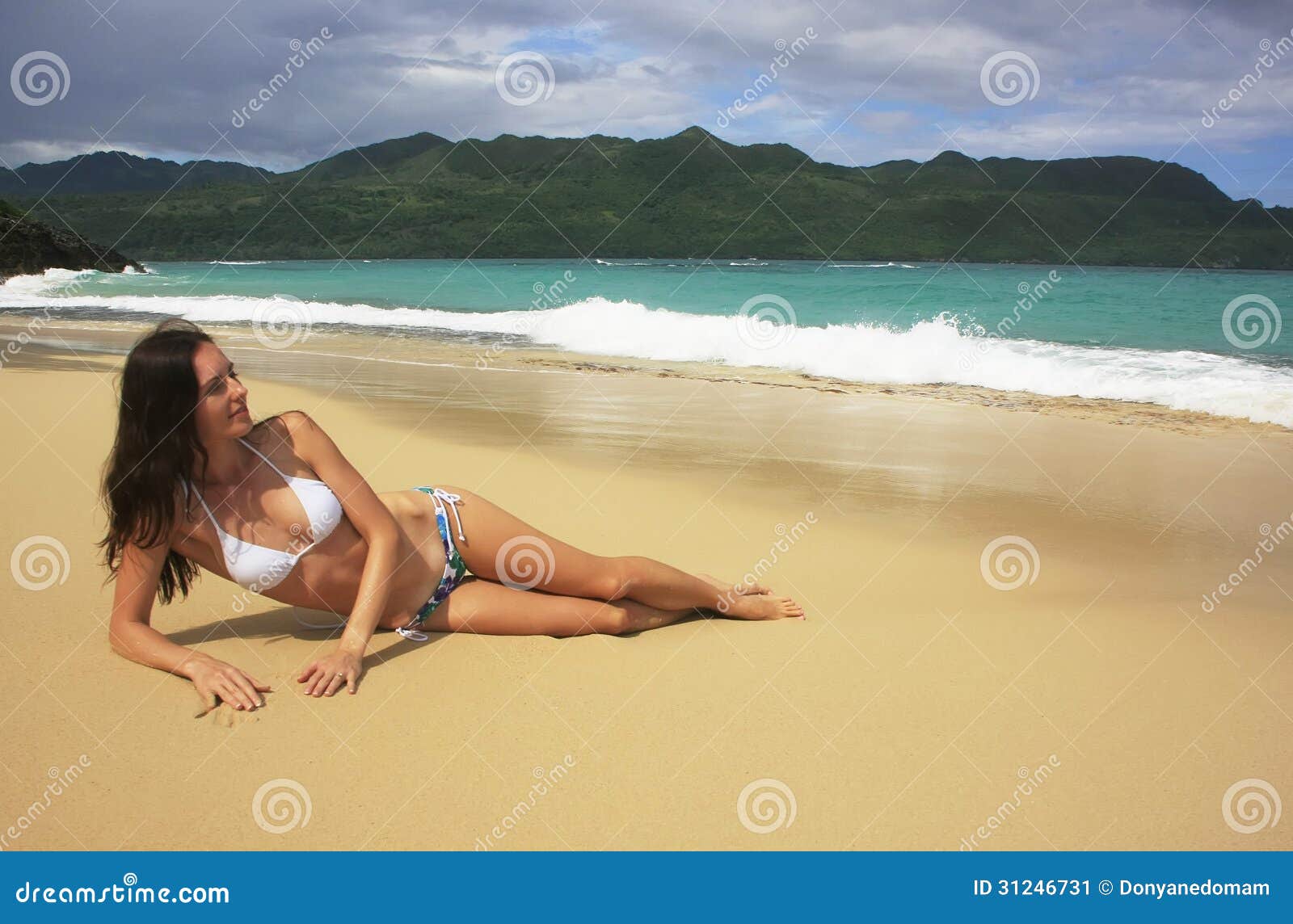 young woman in bikini laying at rincon beach, samana peninsula