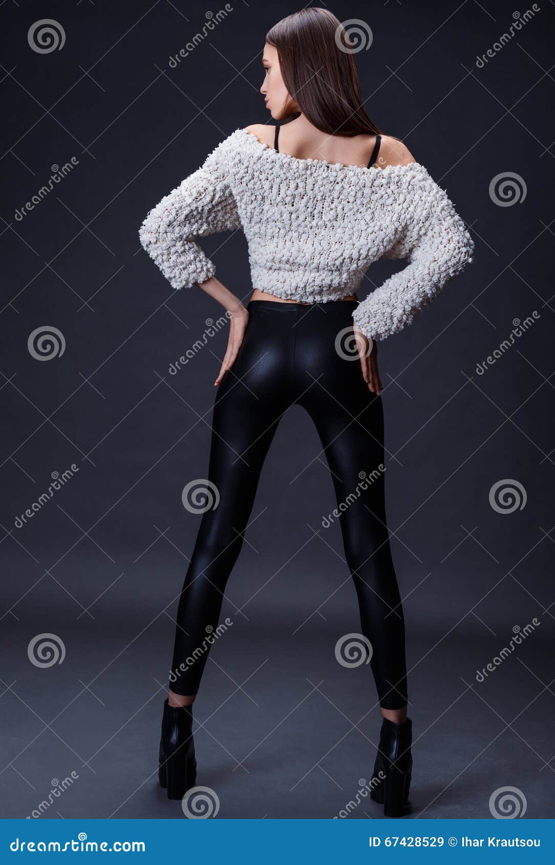 Young Woman in Black Bra and Pants on a Blue Background Stock Image