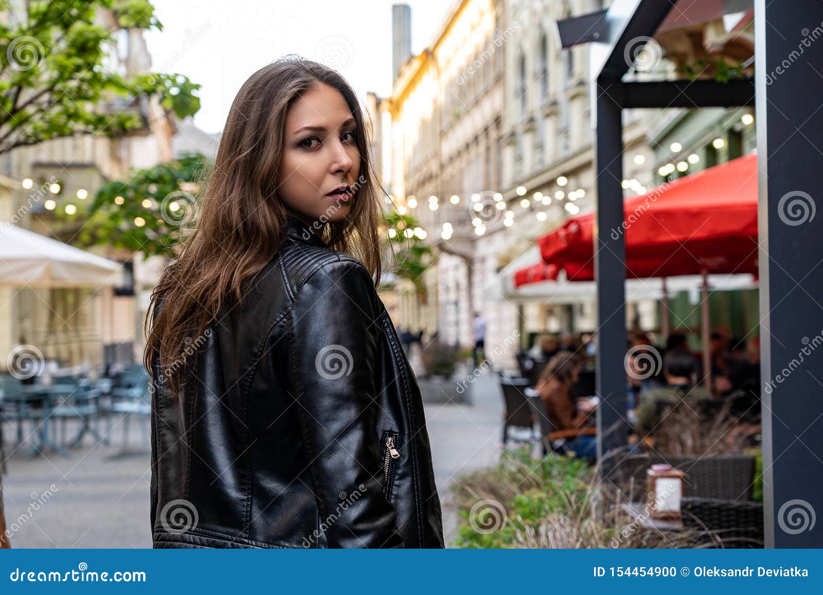 Young Woman in Black Leather Jacket Stand Half a Turn on the Street of ...