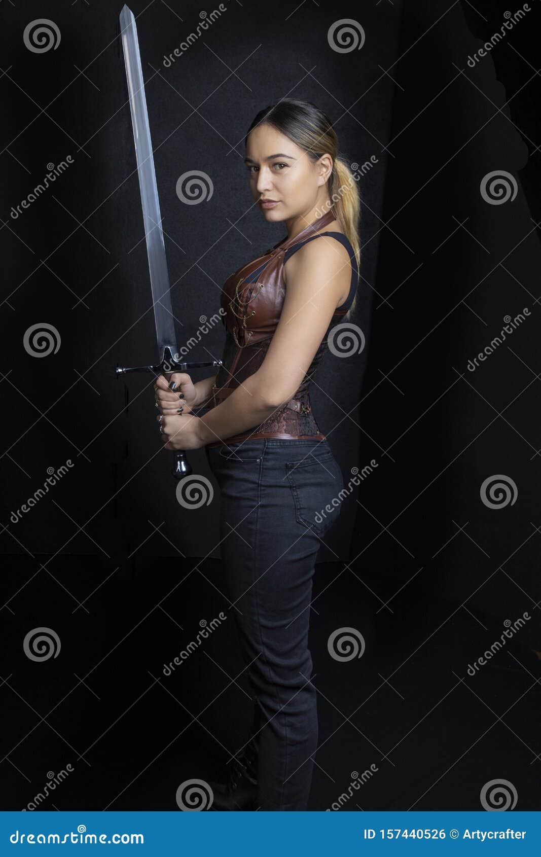 young woman in urban fantasy poses on a black background