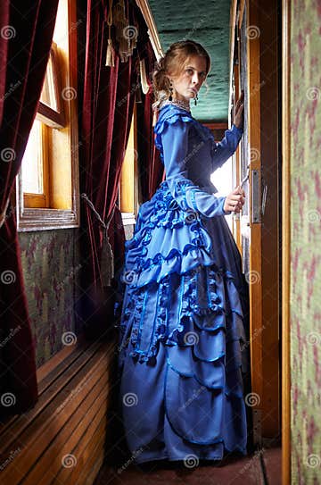 Young Woman in Blue Vintage Dress Standing in Corridor of Retro Stock ...