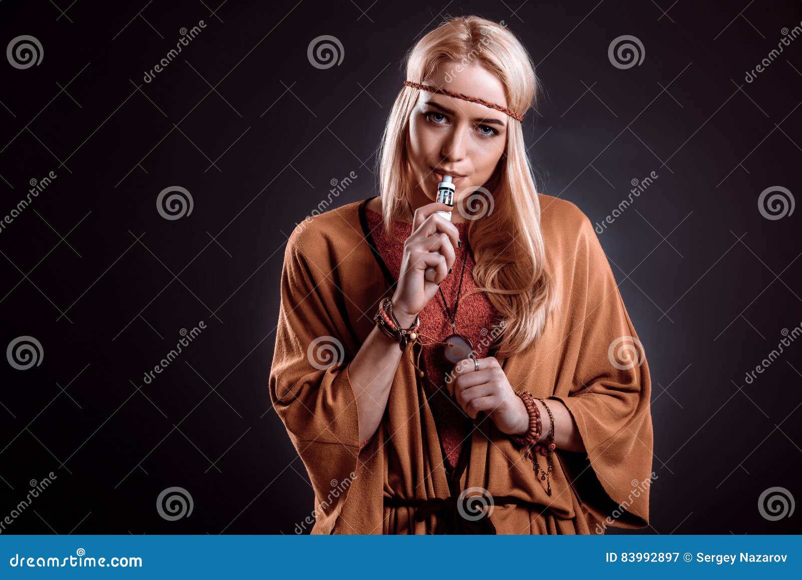 Young Woman In The Boho Style Blowing Smoke Stock Image