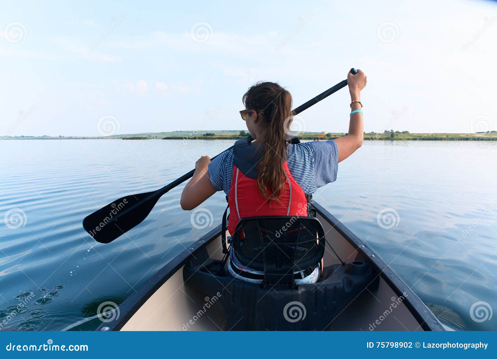 Young Woman Canoeing in the Lake on a Summer Day. Stock Photo - Image ...