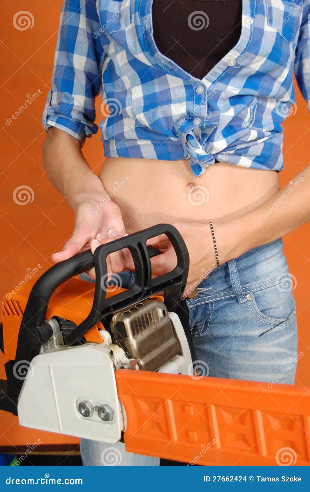 The Young Woman with a Chainsaw Stock Photo Image of power, orange