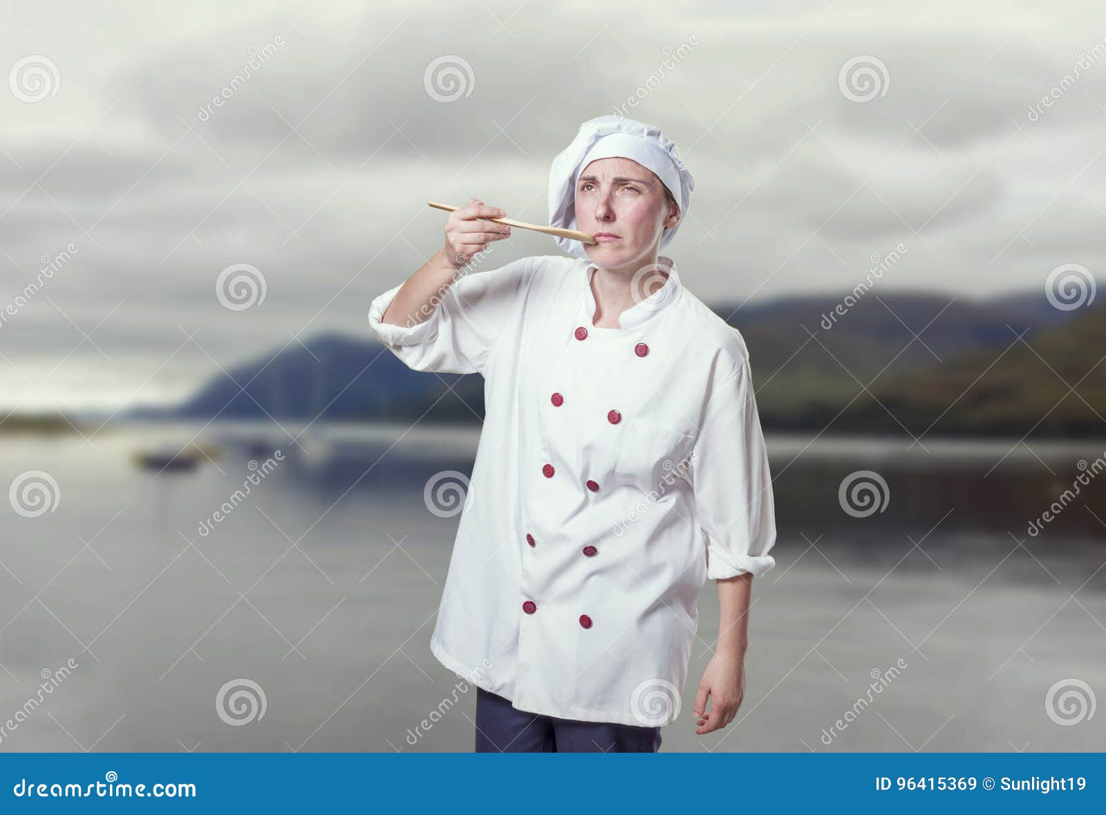 young woman chef is making a traste food gesture
