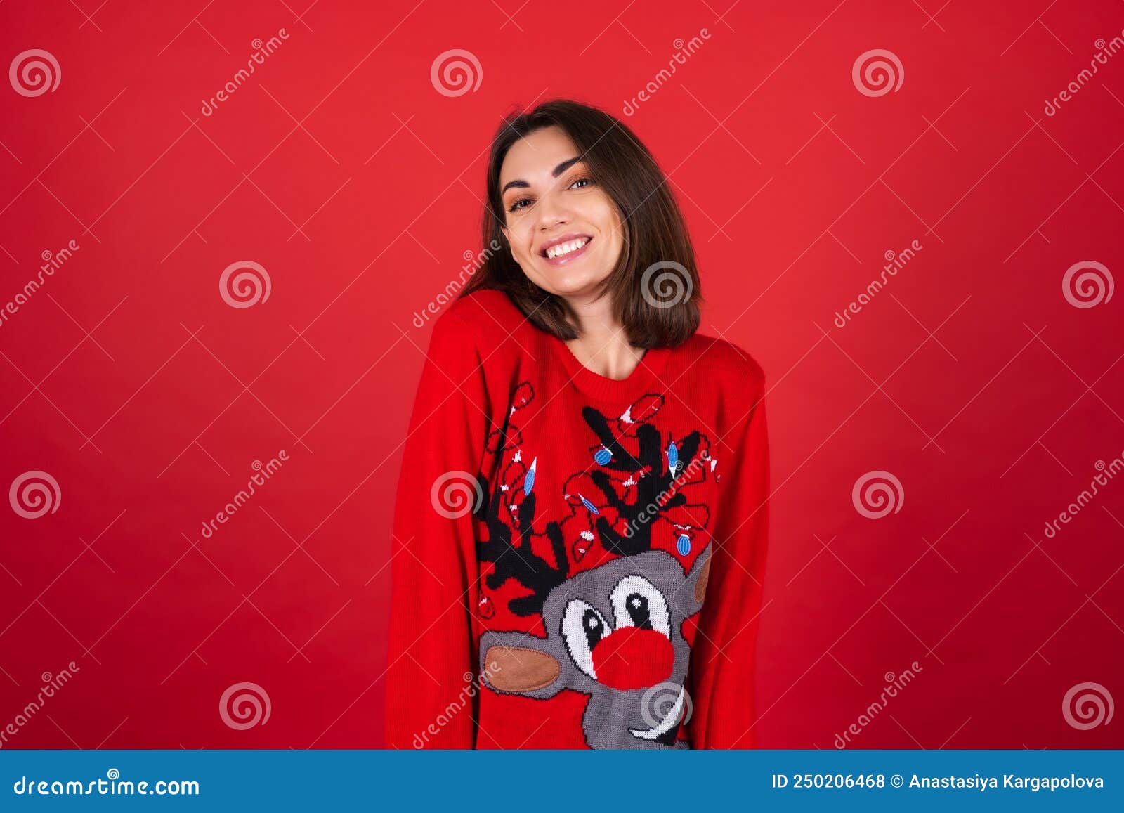 young woman in a christmas sweater on a red background