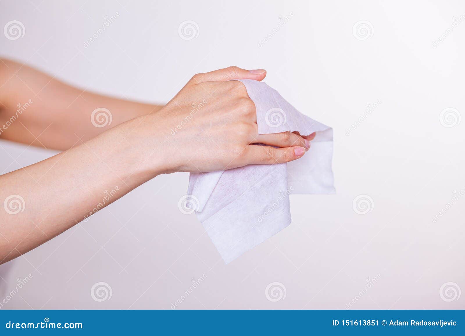 two hands cleaning with wet wipes