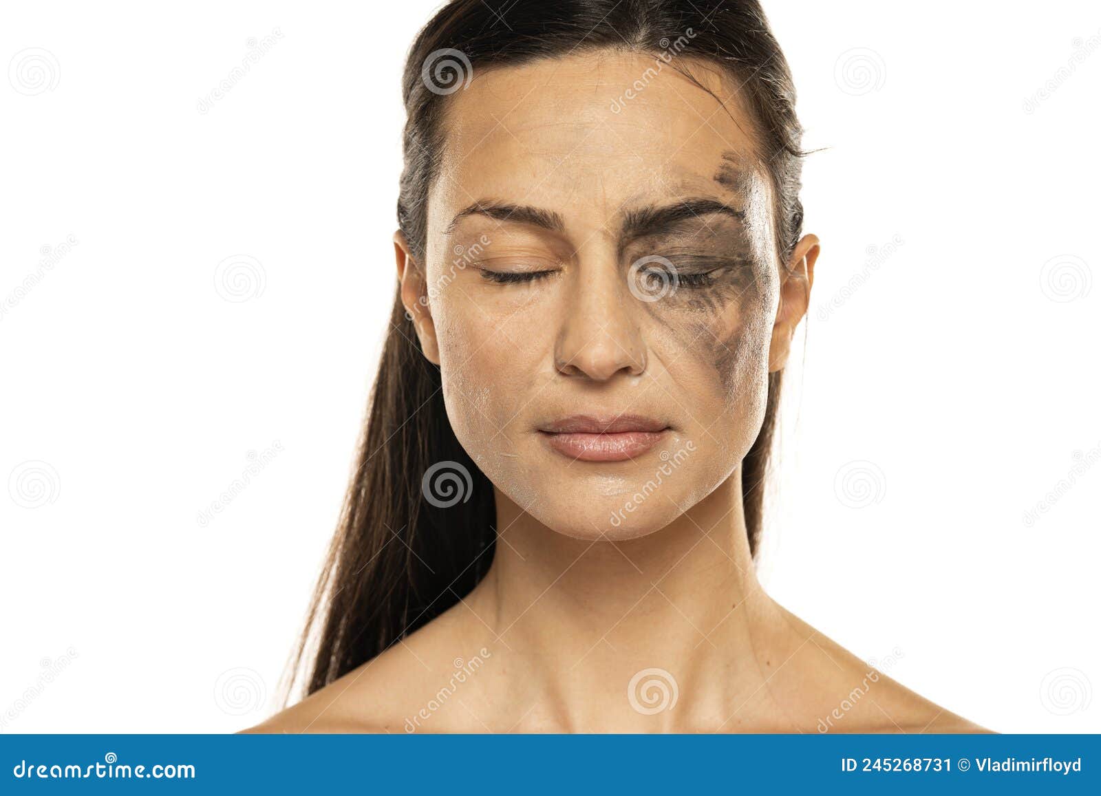 a young woman with closed eyes posing with half face dirty and half cleansed of makeup on a white background