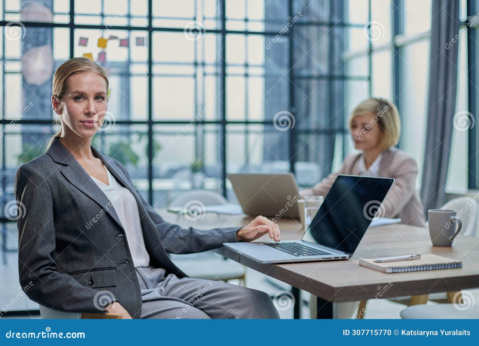 young woman with computers at desk in office