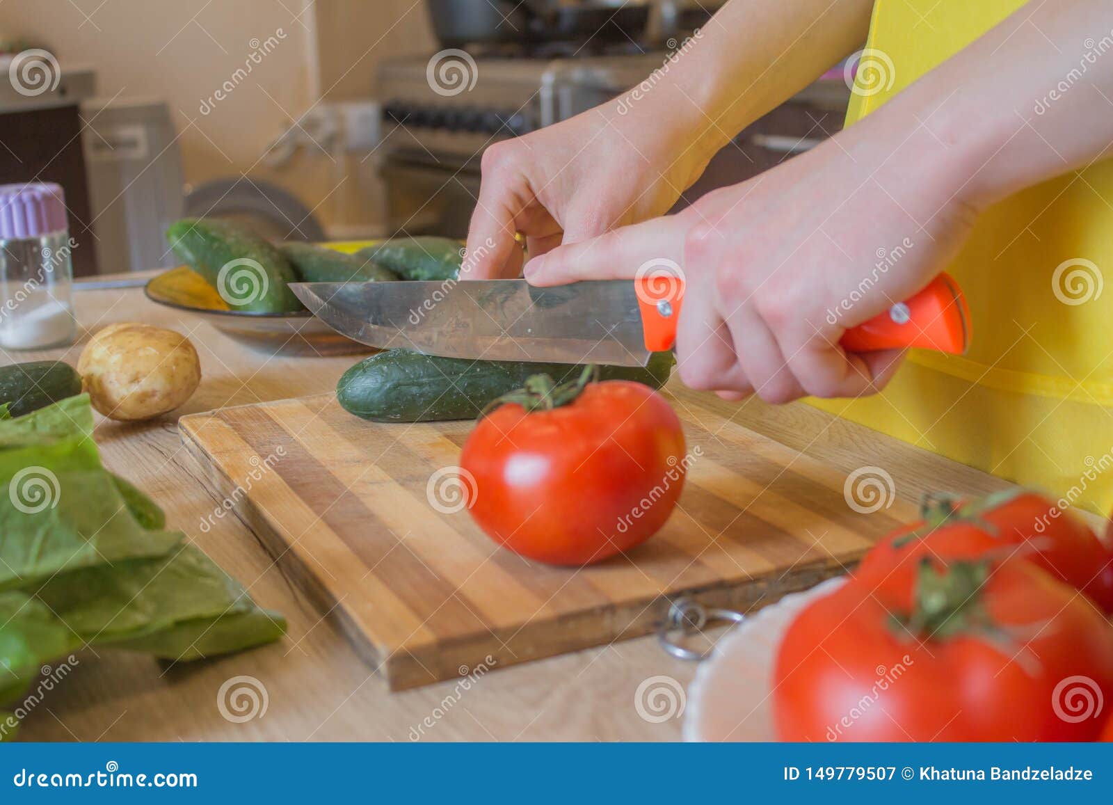 Young Woman Cooking in the Kitchen. Cropped Image of Young Girl Cutting ...