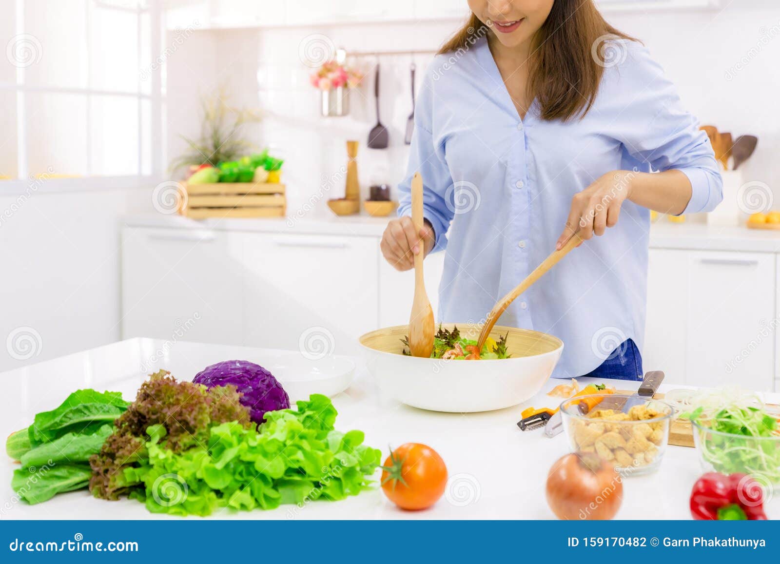 young woman cooking in the kitchen. healthy food - vegetable salad. diet. dieting concept. healthy lifestyle. cooking at home.