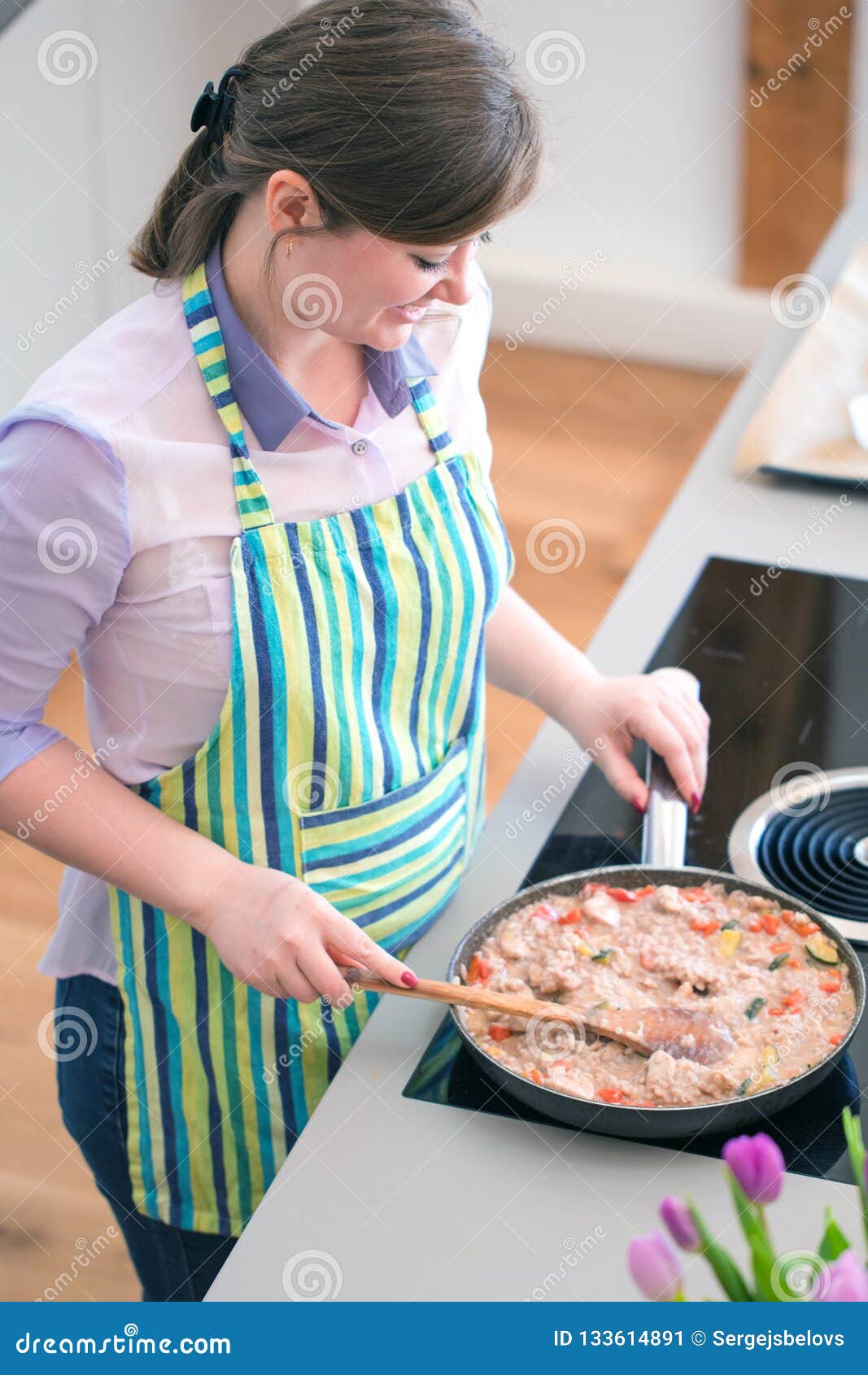 Young Woman Cooking In The Kit