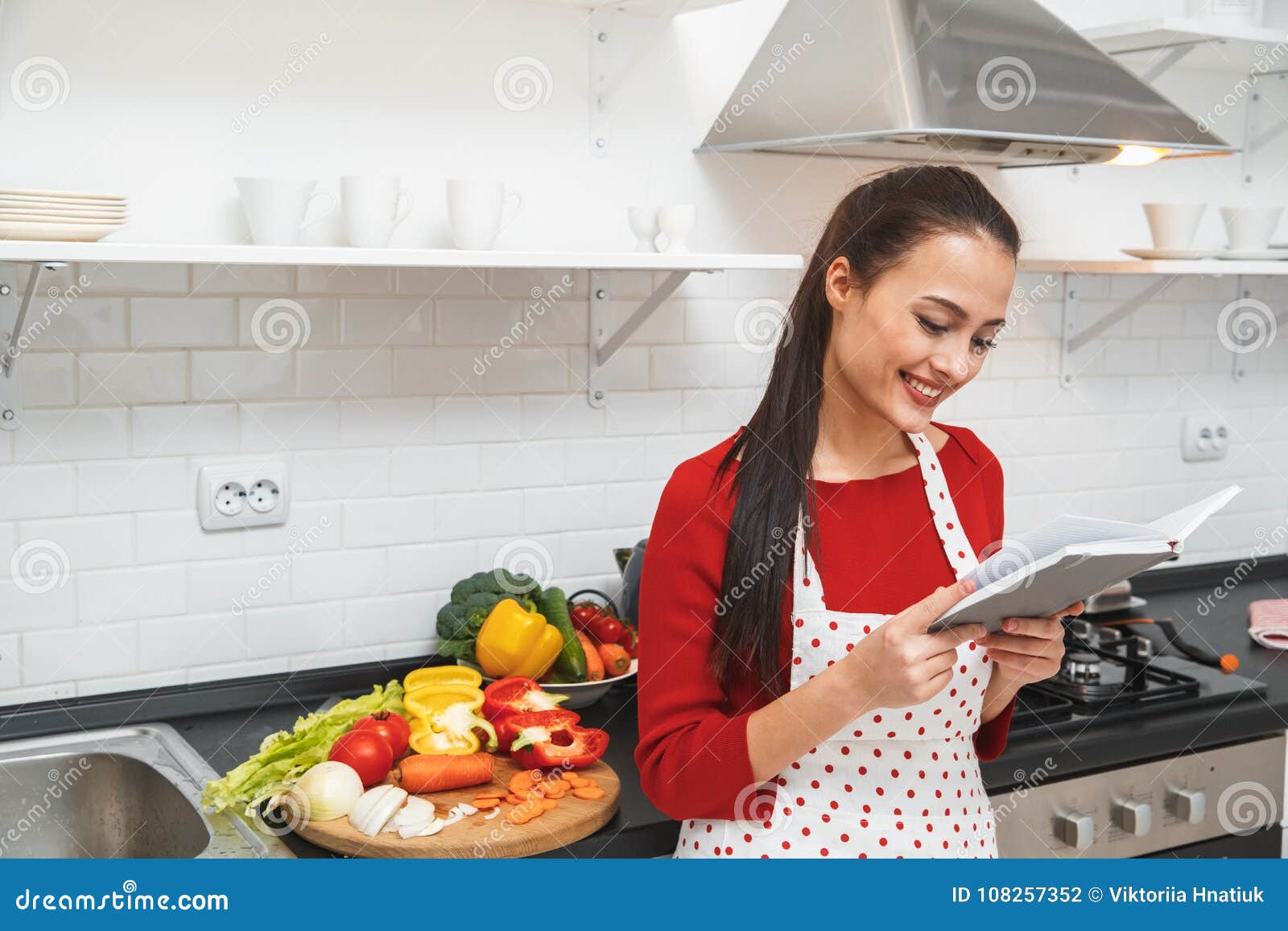 Young Woman Cooking Romantic  Dinner At Home  Reading 