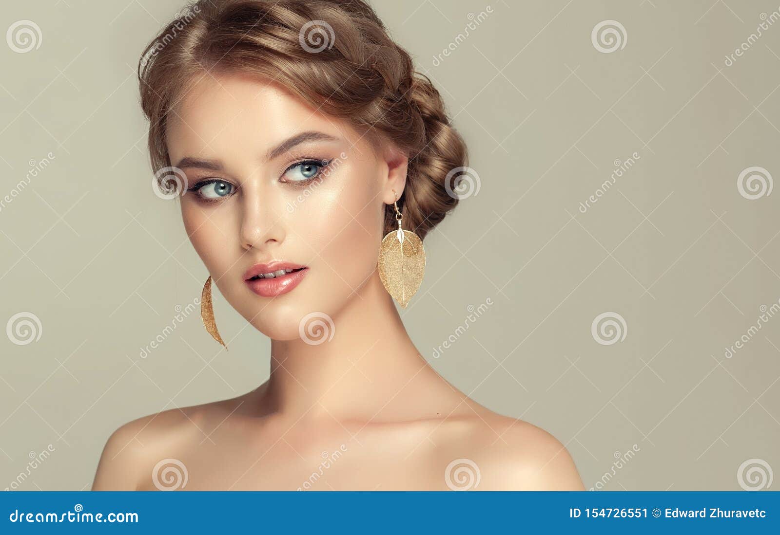 young woman is demonstrating deep blonde hair gathered in elegant hairstyle.