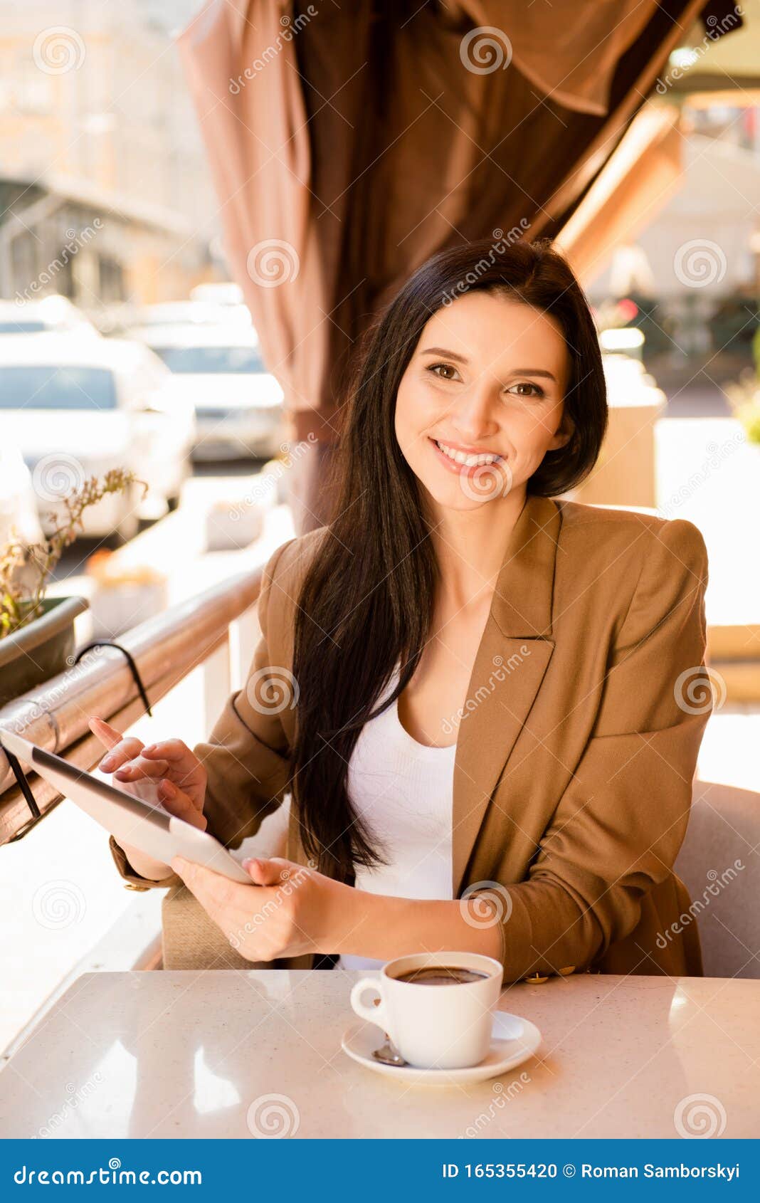 young woman with digitale tablet and cup of coffee in cafe
