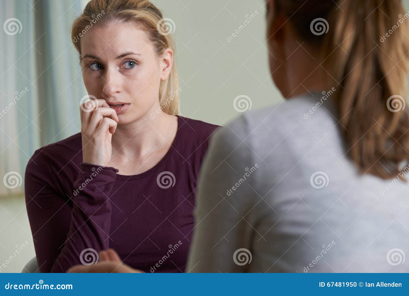 young woman discussing problems with counselor