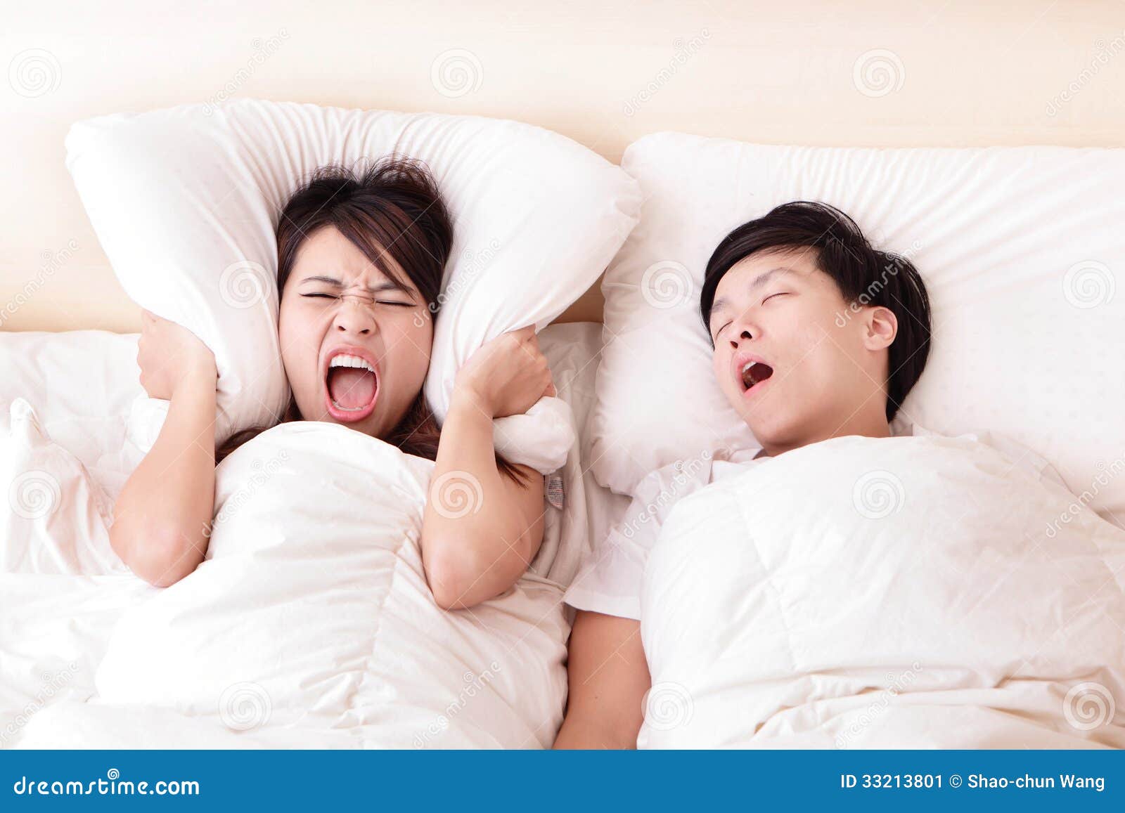 young woman disturbed by the snores of her husband
