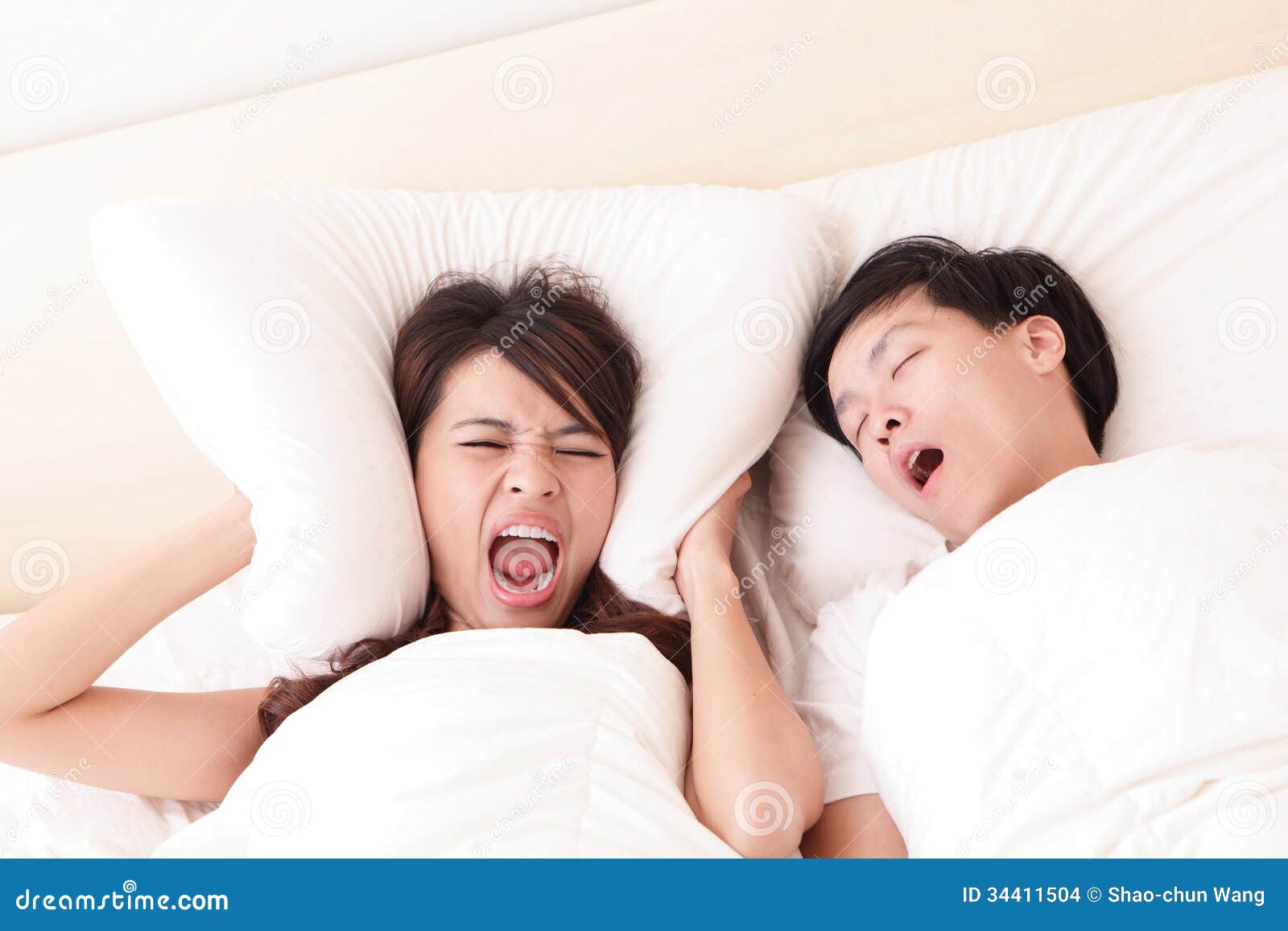 young woman disturbed by the snores of her husband